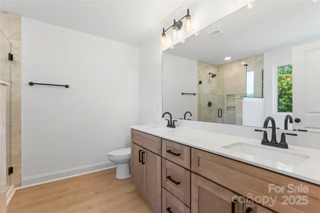 a bathroom with a tub shower and sink