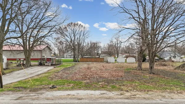 a view of a yard with a house and trees