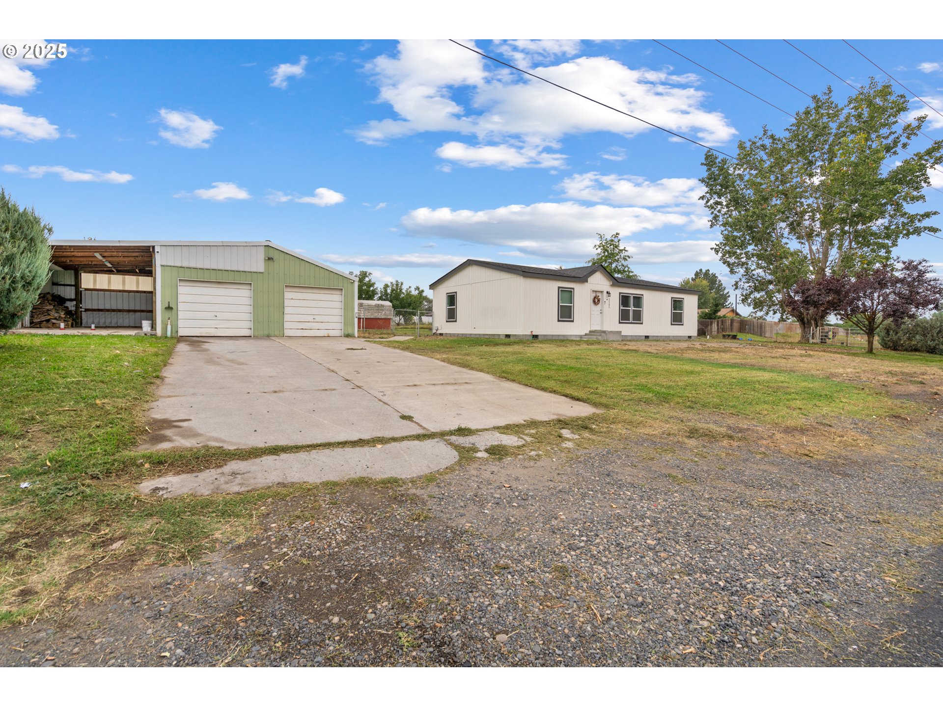 32390 East Punkin Center Road Hermiston, OR 97838 - Photo 1 of 17 a view of a big yard next to a house
