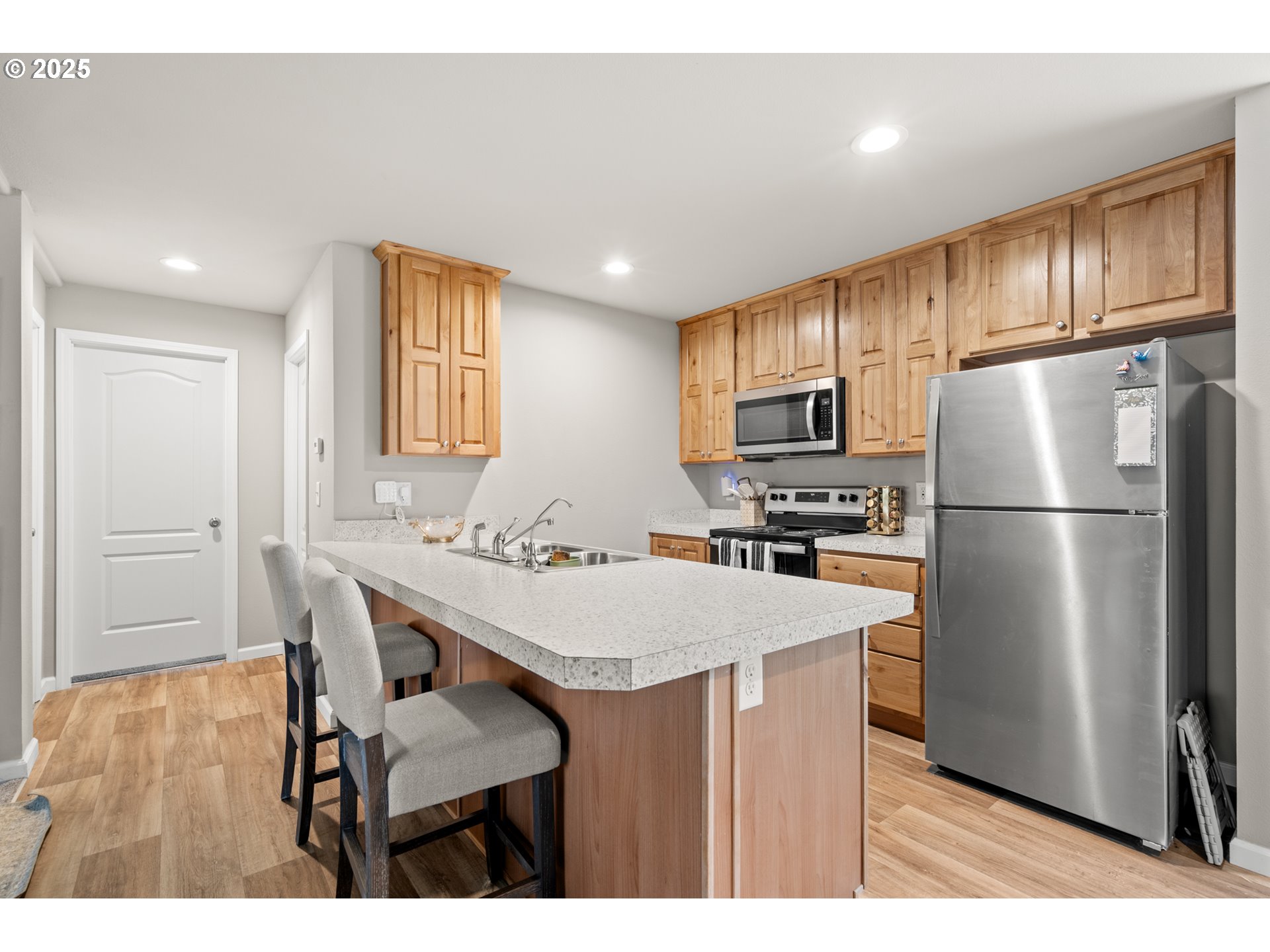 32390 East Punkin Center Road Hermiston, OR 97838 - Photo 3 of 17 a kitchen with refrigerator cabinets and wooden floor