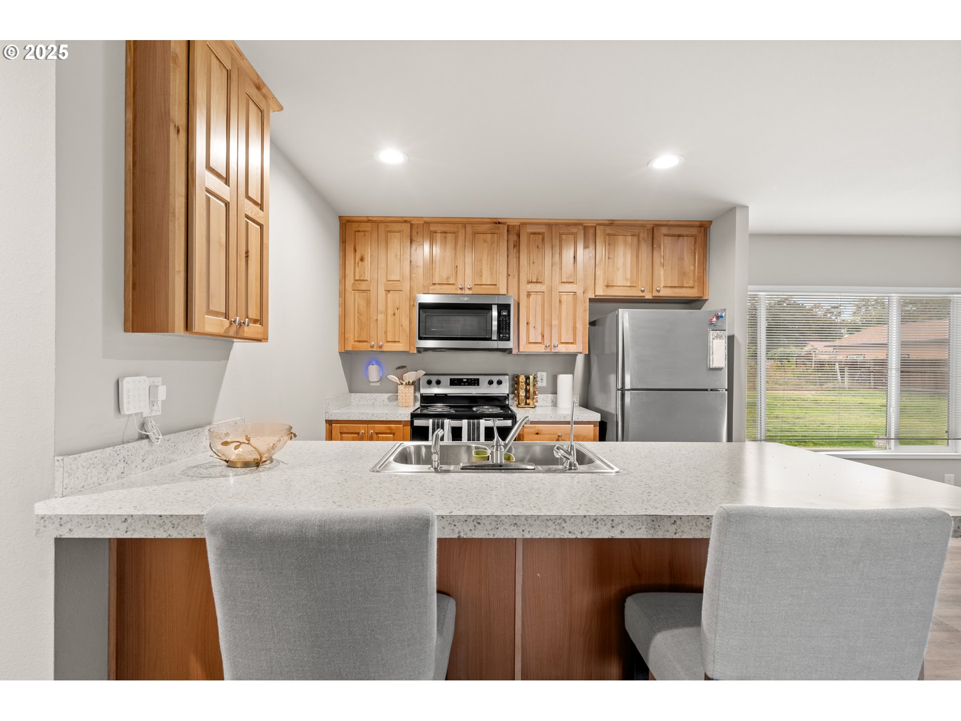 32390 East Punkin Center Road Hermiston, OR 97838 - Photo 4 of 17 a kitchen with refrigerator cabinets and wooden floor