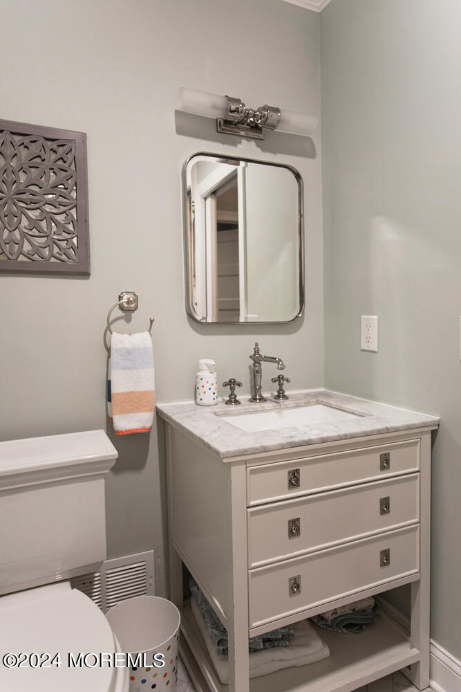 162 Twin Brooks Avenue Middletown, NJ 07748 - Photo 37 of 60 a bathroom with a toilet a sink and mirror