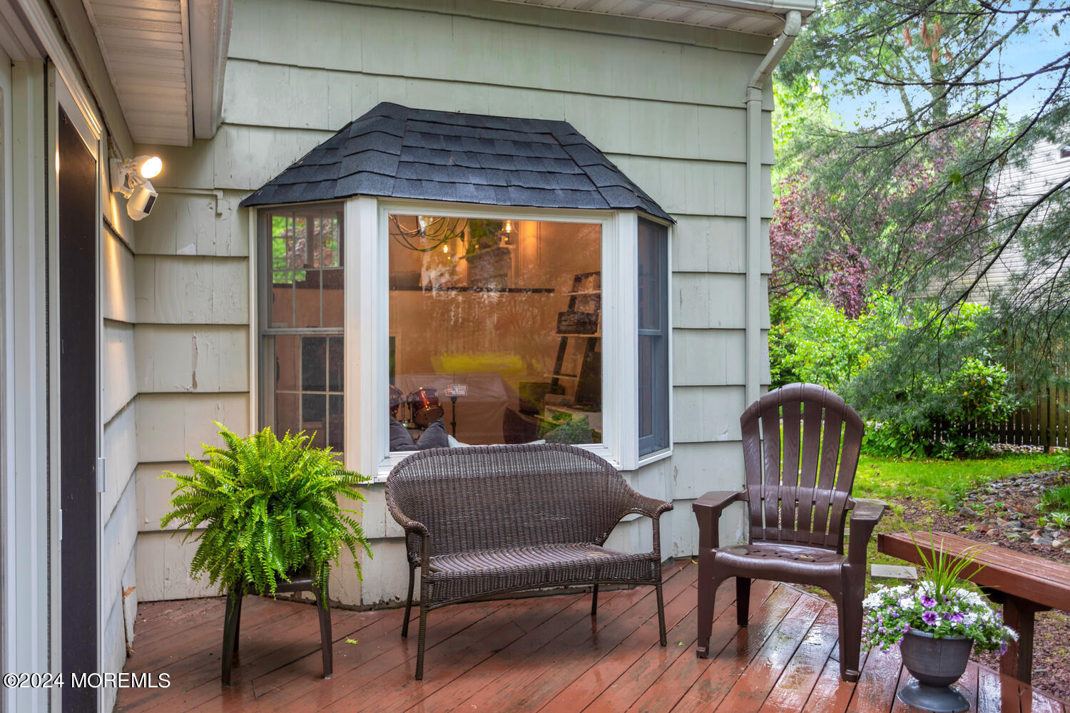 162 Twin Brooks Avenue Middletown, NJ 07748 - Photo 42 of 60 a view of a patio with a table chairs and a potted plant