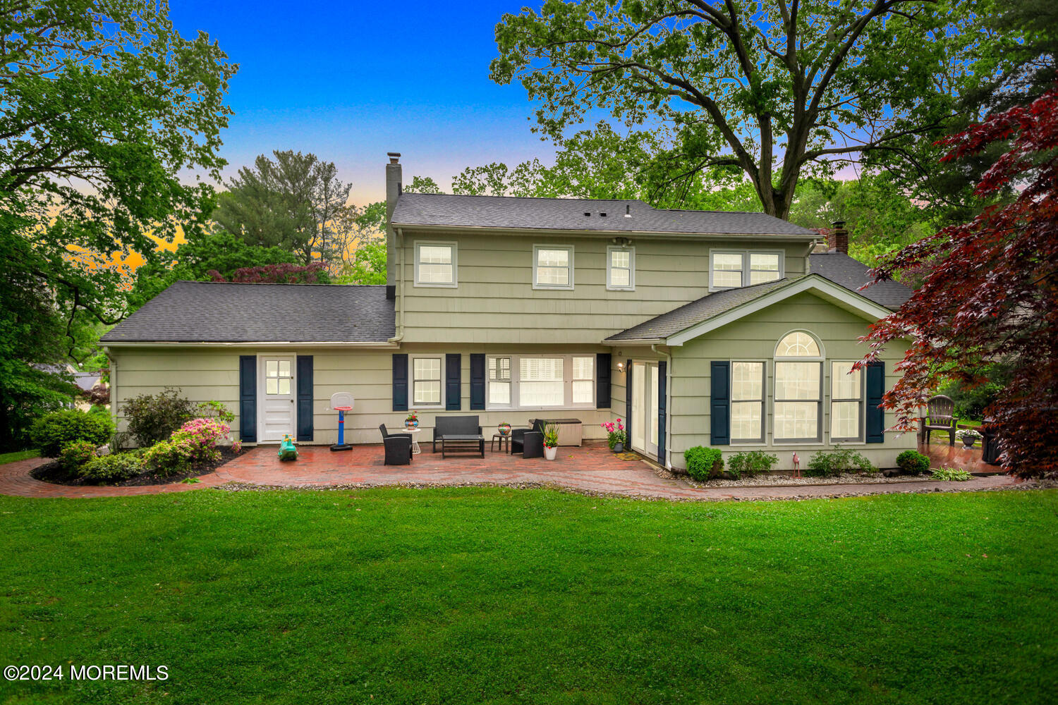 162 Twin Brooks Avenue Middletown, NJ 07748 - Photo 56 of 60 a front view of a house with a garden and trees