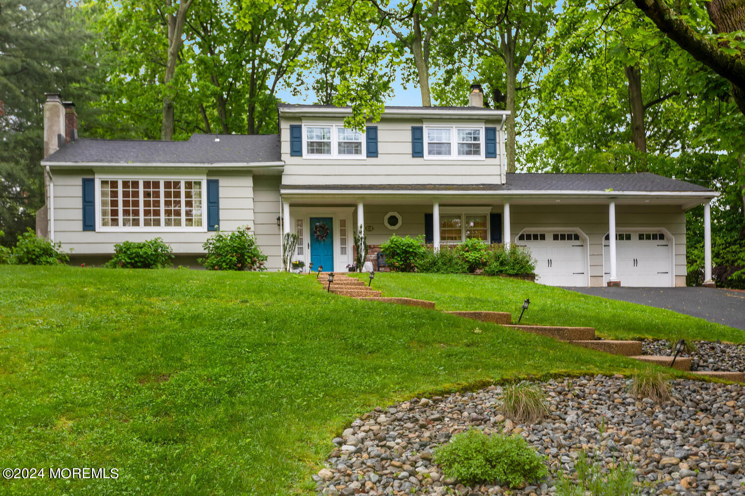 162 Twin Brooks Avenue Middletown, NJ 07748 - Photo 59 of 60 a front view of a house with garden and porch
