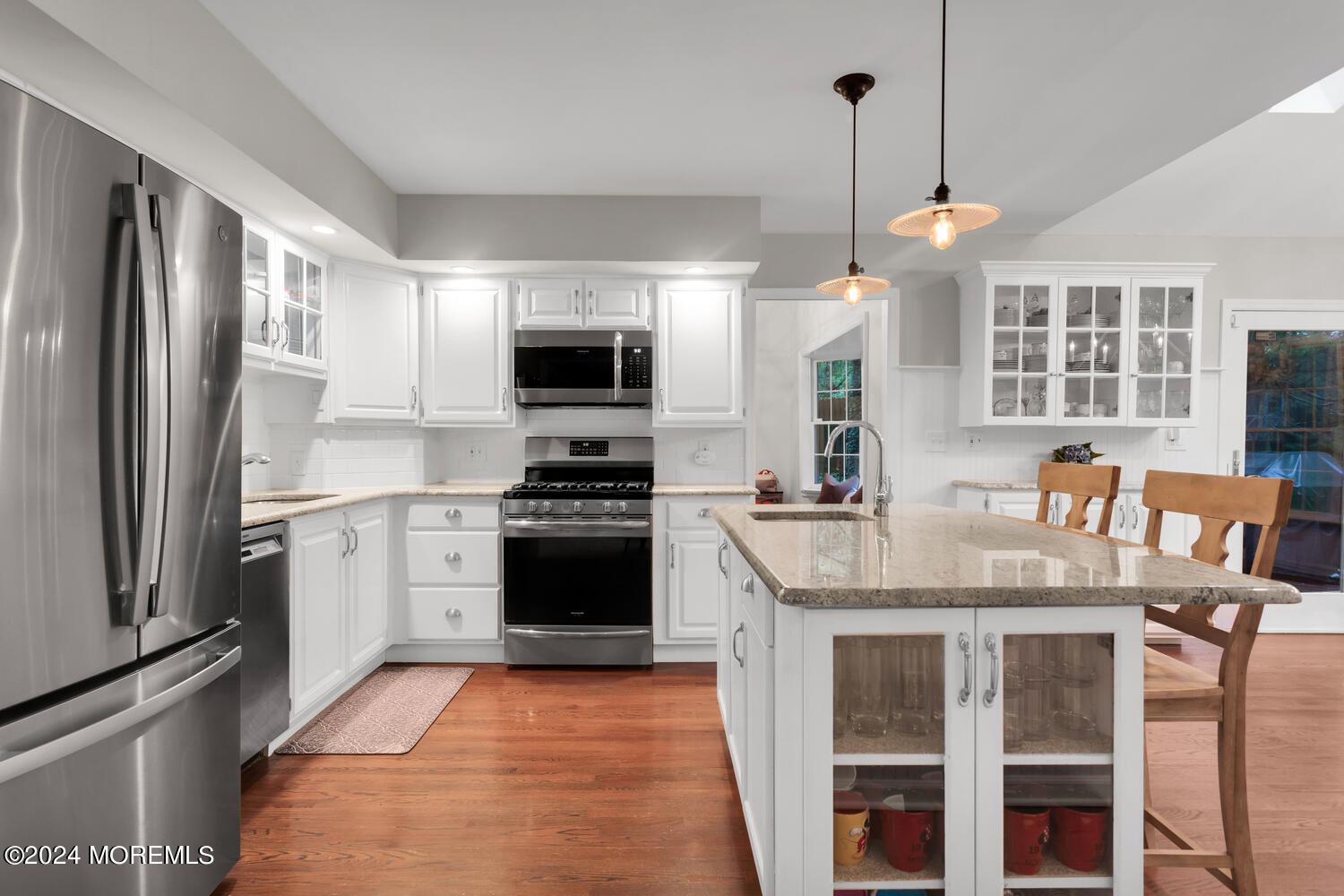 162 Twin Brooks Avenue Middletown, NJ 07748 - Photo 8 of 60 a kitchen with kitchen island granite countertop a stove top oven a sink dishwasher a refrigerator and a dining table with wooden floor