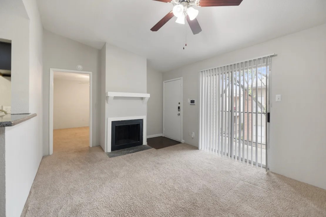 2800 South Ashford Road, Unit 1218 Houston, TX 77082 - Photo 25 of 35 an empty room with windows fireplace and fan