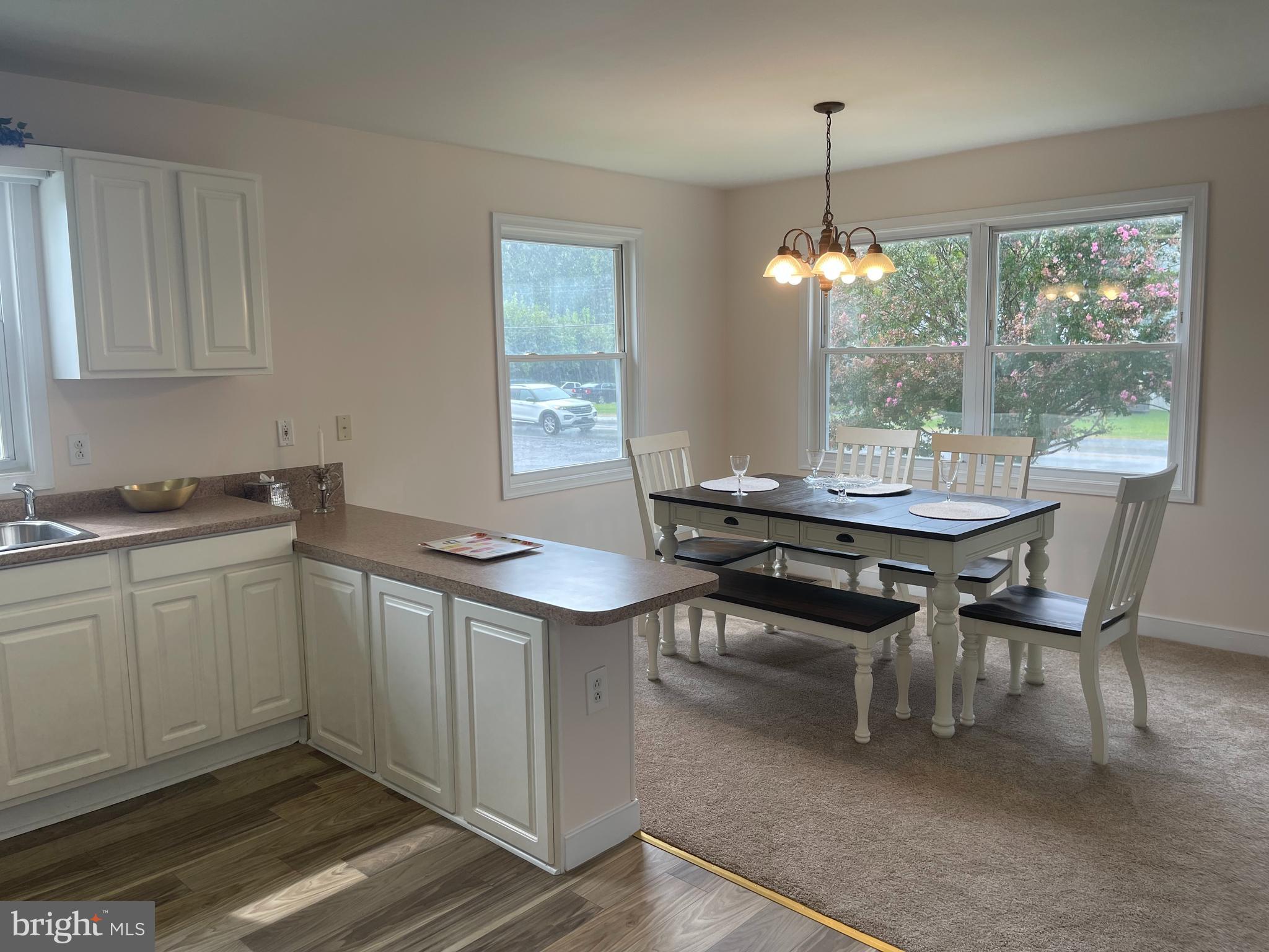 547 Compass Road East Middle River, MD 21220 - Photo 6 of 16 a kitchen with a sink and chairs
