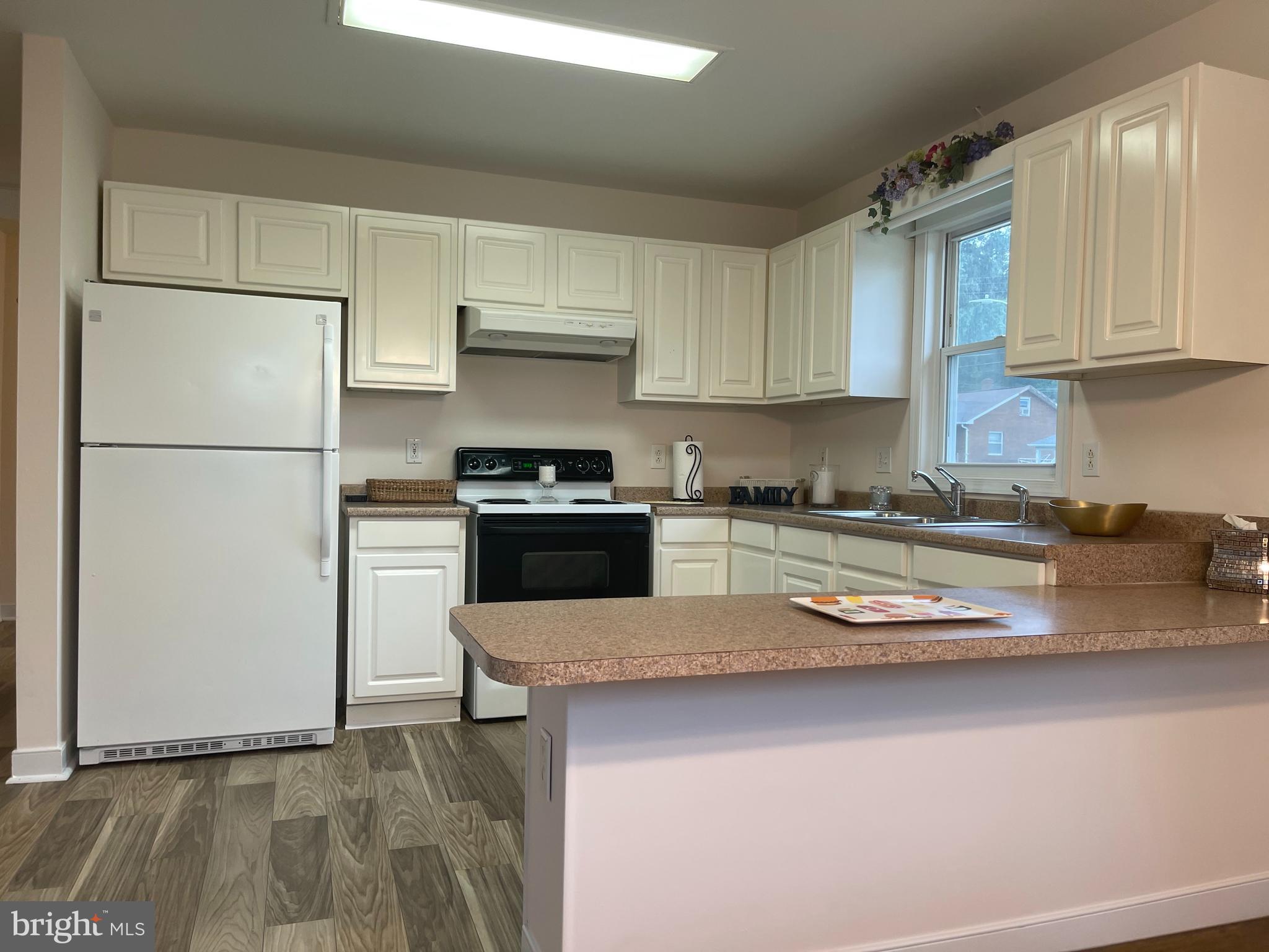 547 Compass Road East Middle River, MD 21220 - Photo 8 of 16 a kitchen with stainless steel appliances granite countertop a refrigerator sink and stove