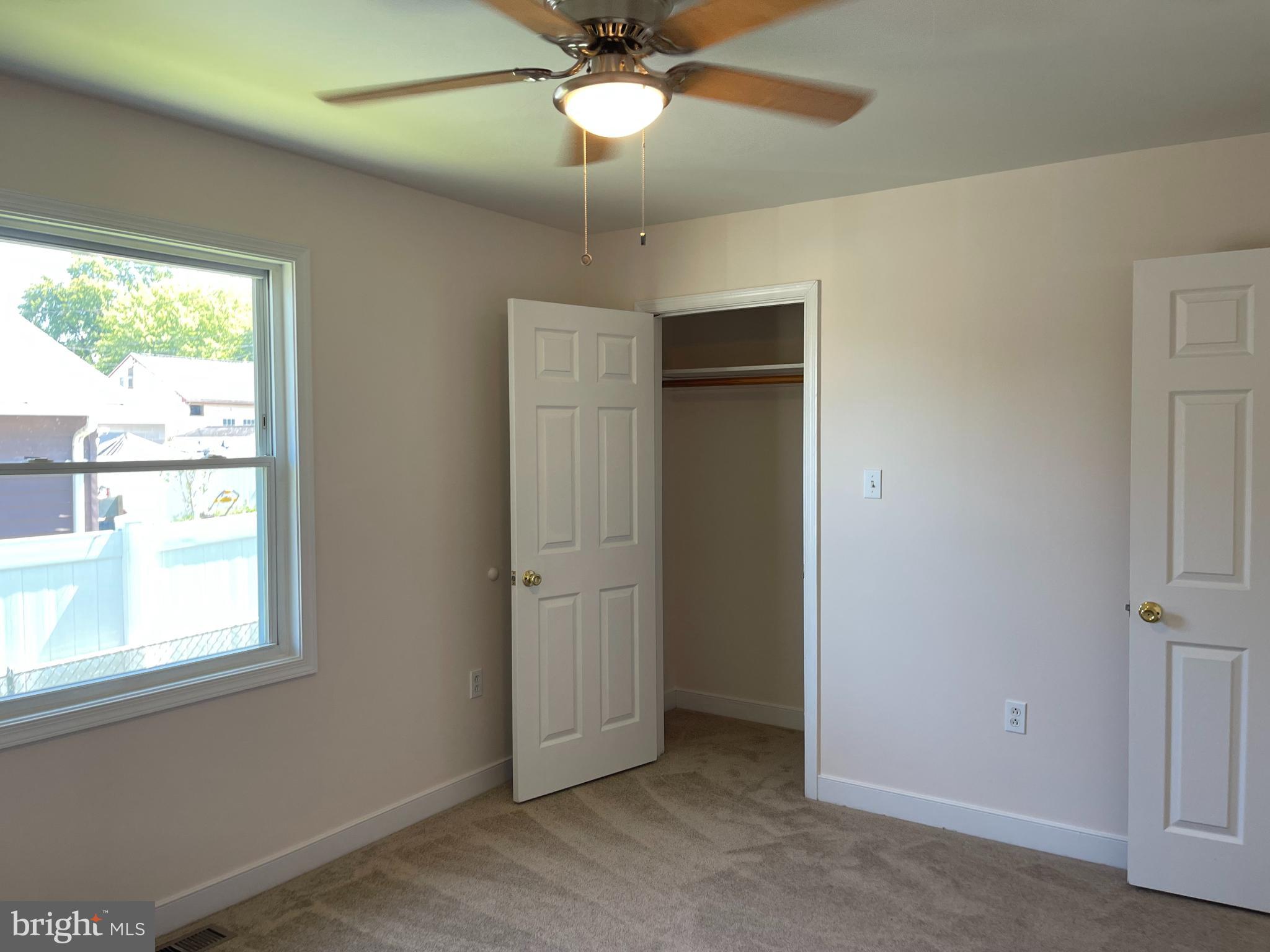 547 Compass Road East Middle River, MD 21220 - Photo 10 of 16 an empty room with windows and fan