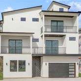 a view of a white building with large windows