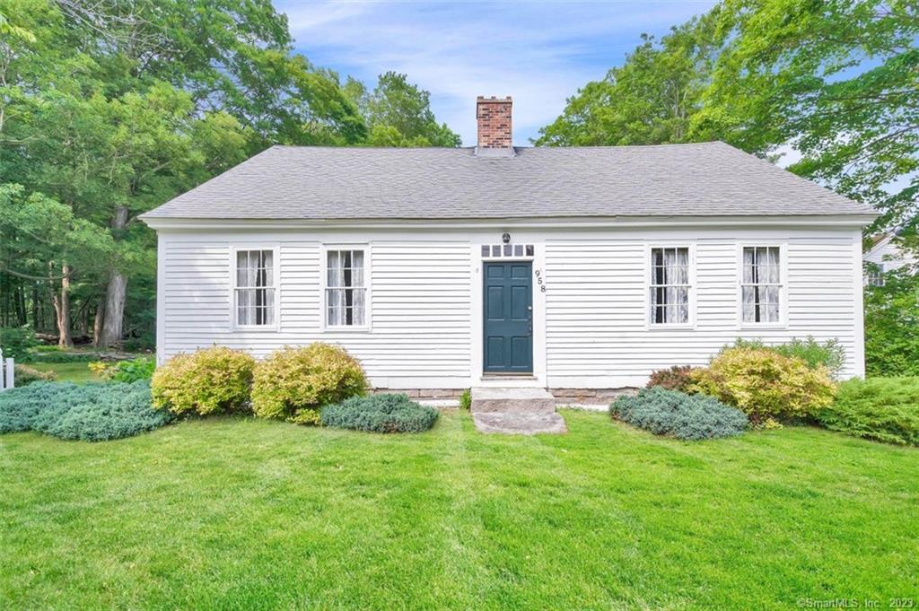 958 Storrs Road Mansfield, CT 06268 - Photo 1 of 1 a backyard of a house with potted plants and large tree