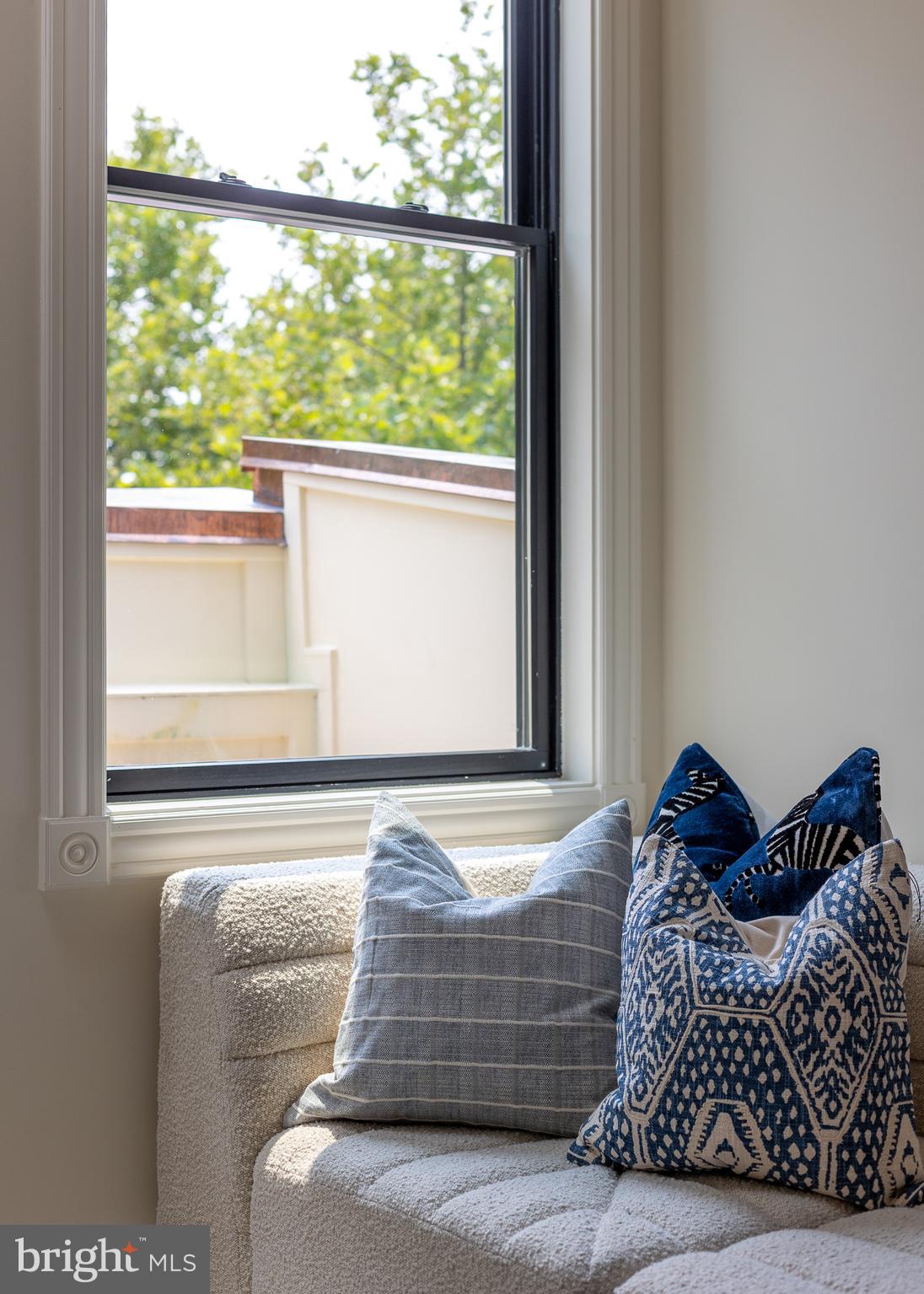 441 Q Street Northwest, Unit PH Washington, DC 20001 - Photo 16 of 55 a bed sitting in a bedroom next to a window