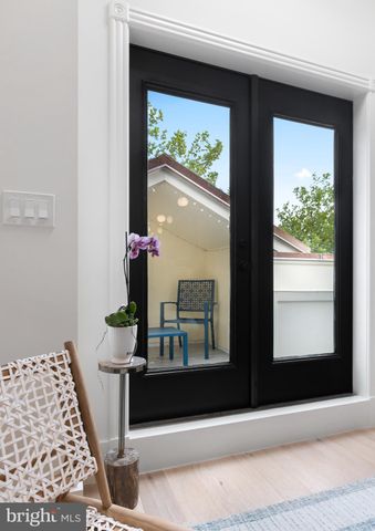 a terrace of a house with wooden floor and outdoor seating