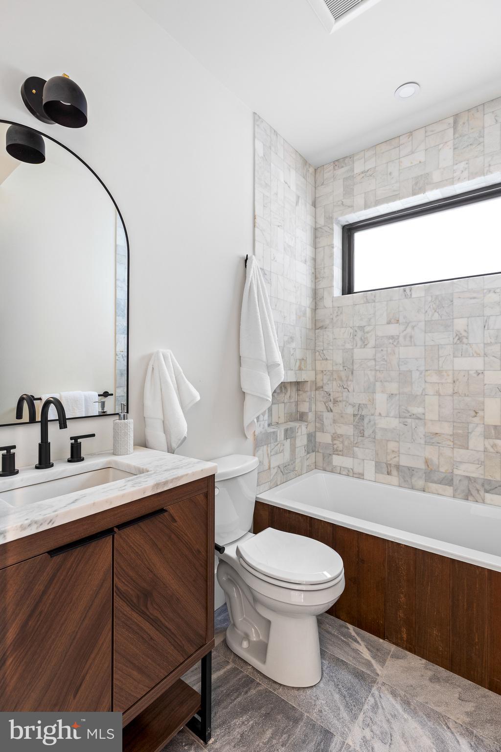 441 Q Street Northwest, Unit PH Washington, DC 20001 - Photo 33 of 55 a bathroom with a toilet a sink and mirror