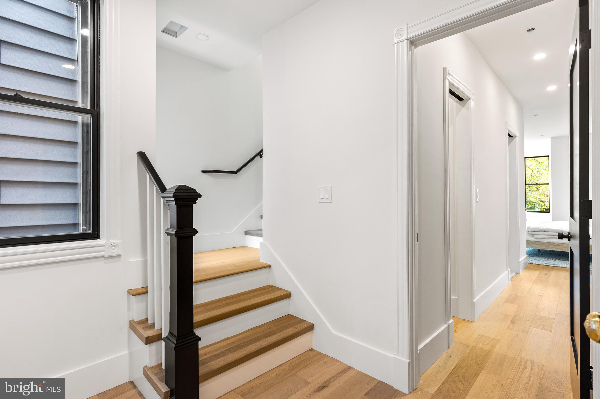 441 Q Street Northwest, Unit PH Washington, DC 20001 - Photo 39 of 55 a view of a hallway with wooden floor and staircase