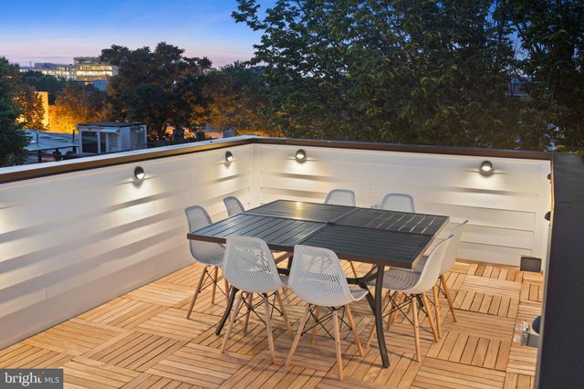 a view of a terrace with furniture and a garden