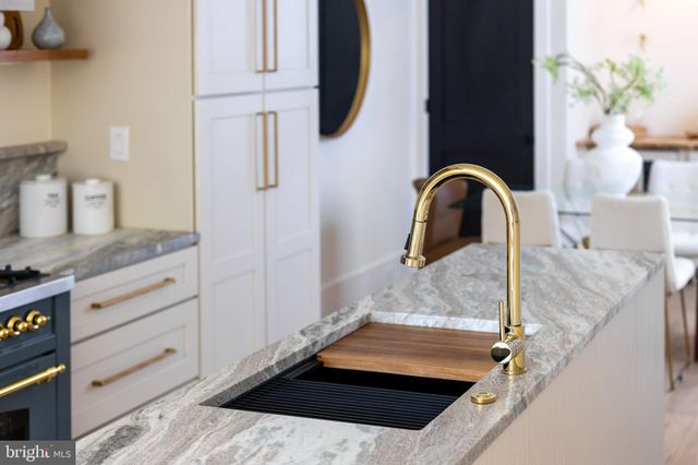 a stove top oven sitting inside of a kitchen