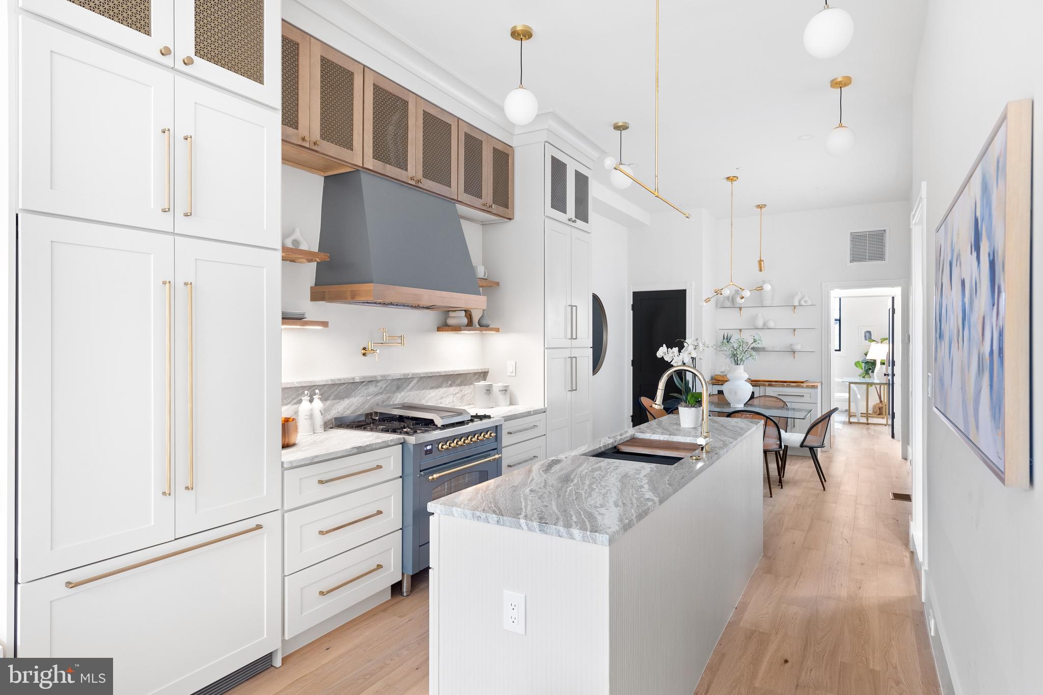 441 Q Street Northwest, Unit PH Washington, DC 20001 - Photo 10 of 55 a kitchen with white cabinets and stainless steel appliances