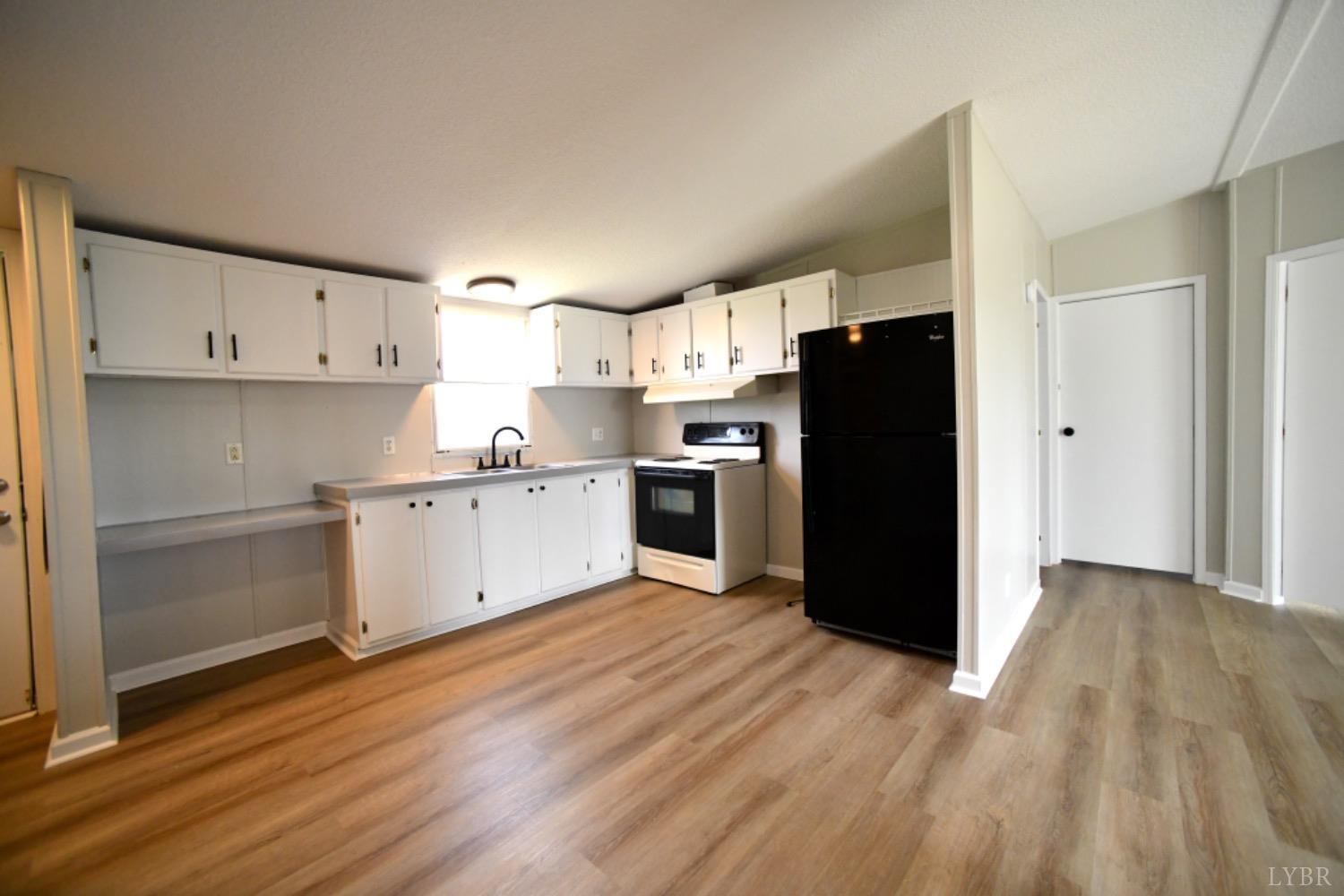 3961 Roark Mill Road Hurt, VA 24563 - Photo 12 of 28 a kitchen with a refrigerator and a sink