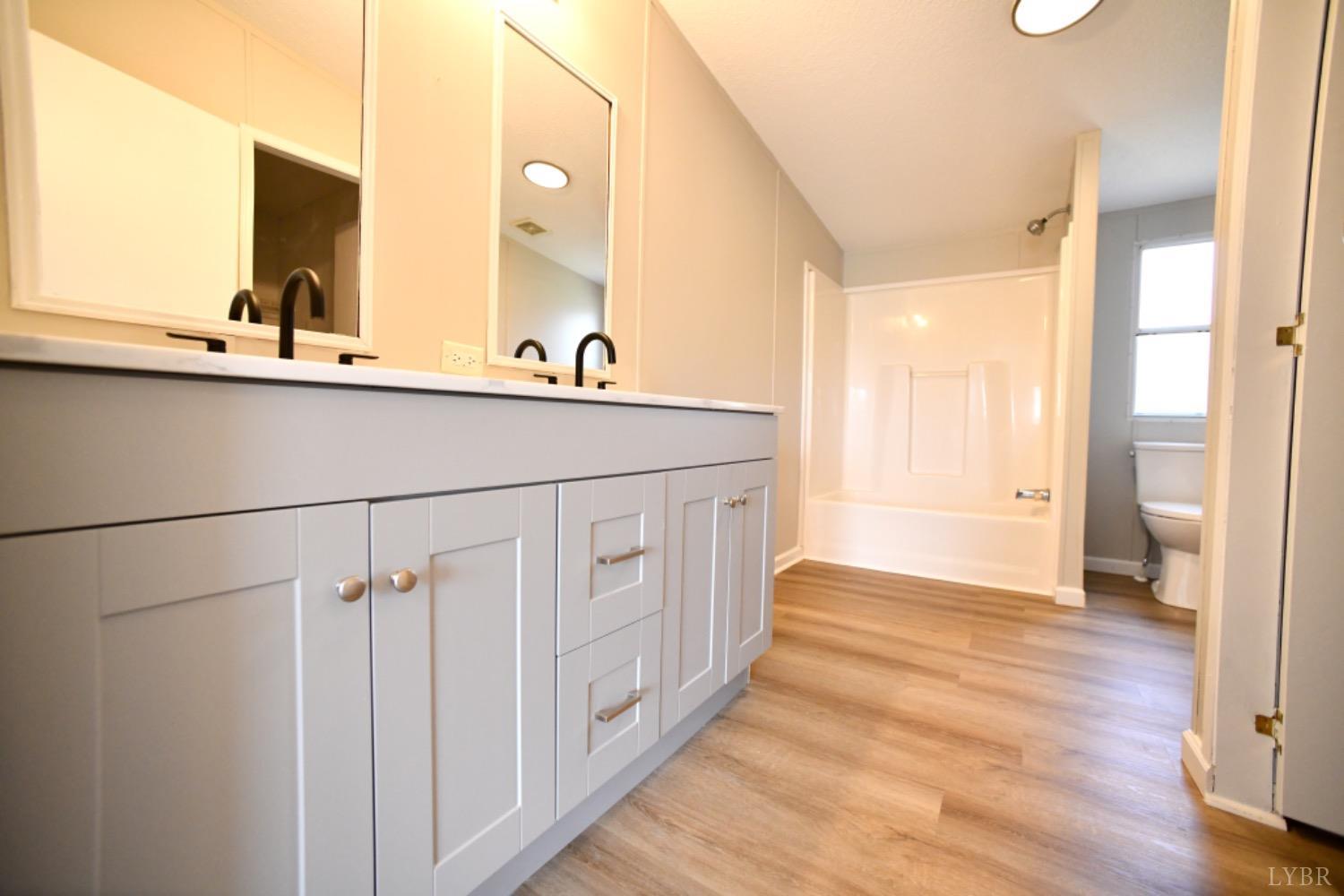 3961 Roark Mill Road Hurt, VA 24563 - Photo 20 of 28 a bathroom with a sink and a mirror