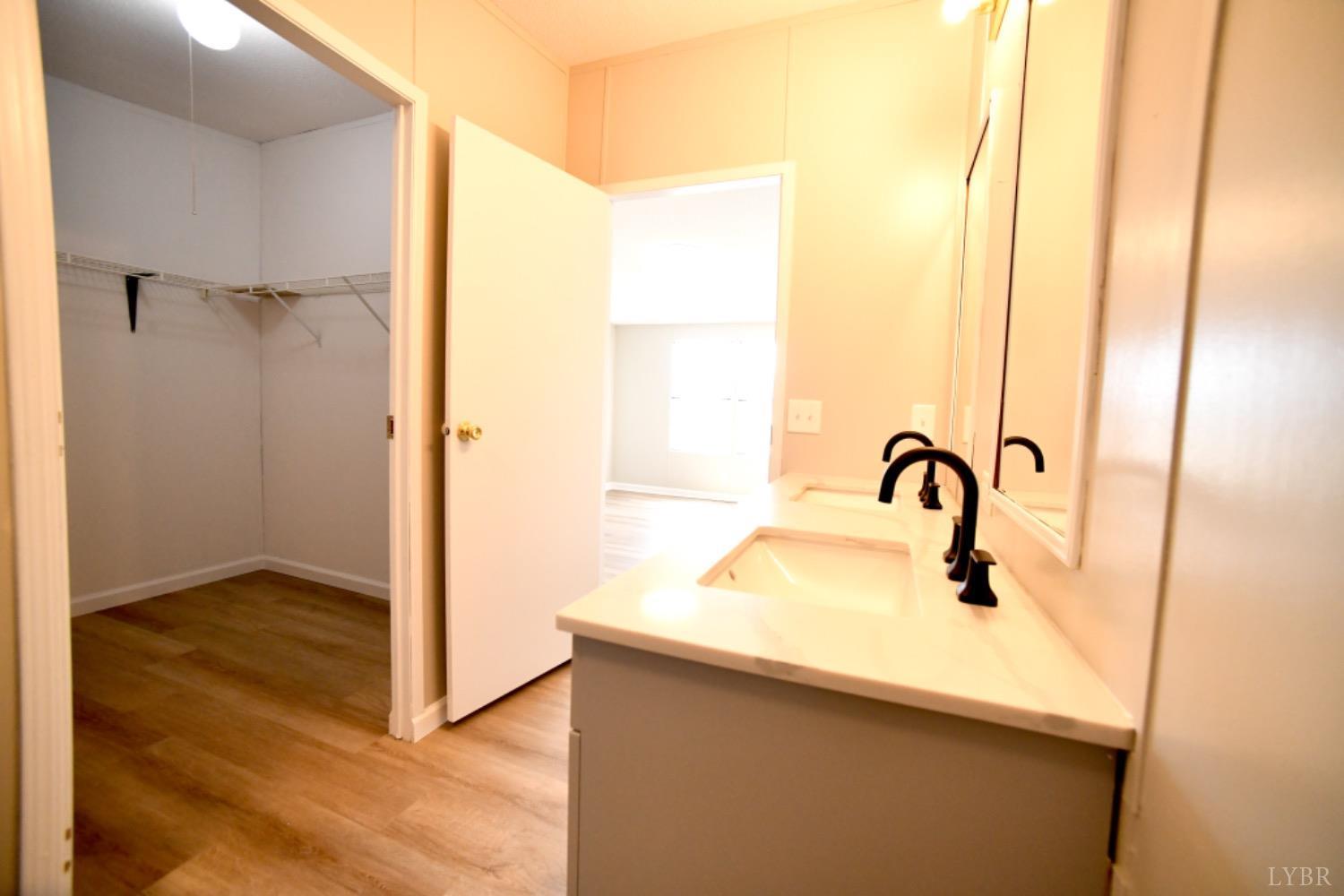 3961 Roark Mill Road Hurt, VA 24563 - Photo 22 of 28 a bathroom with a sink and a mirror