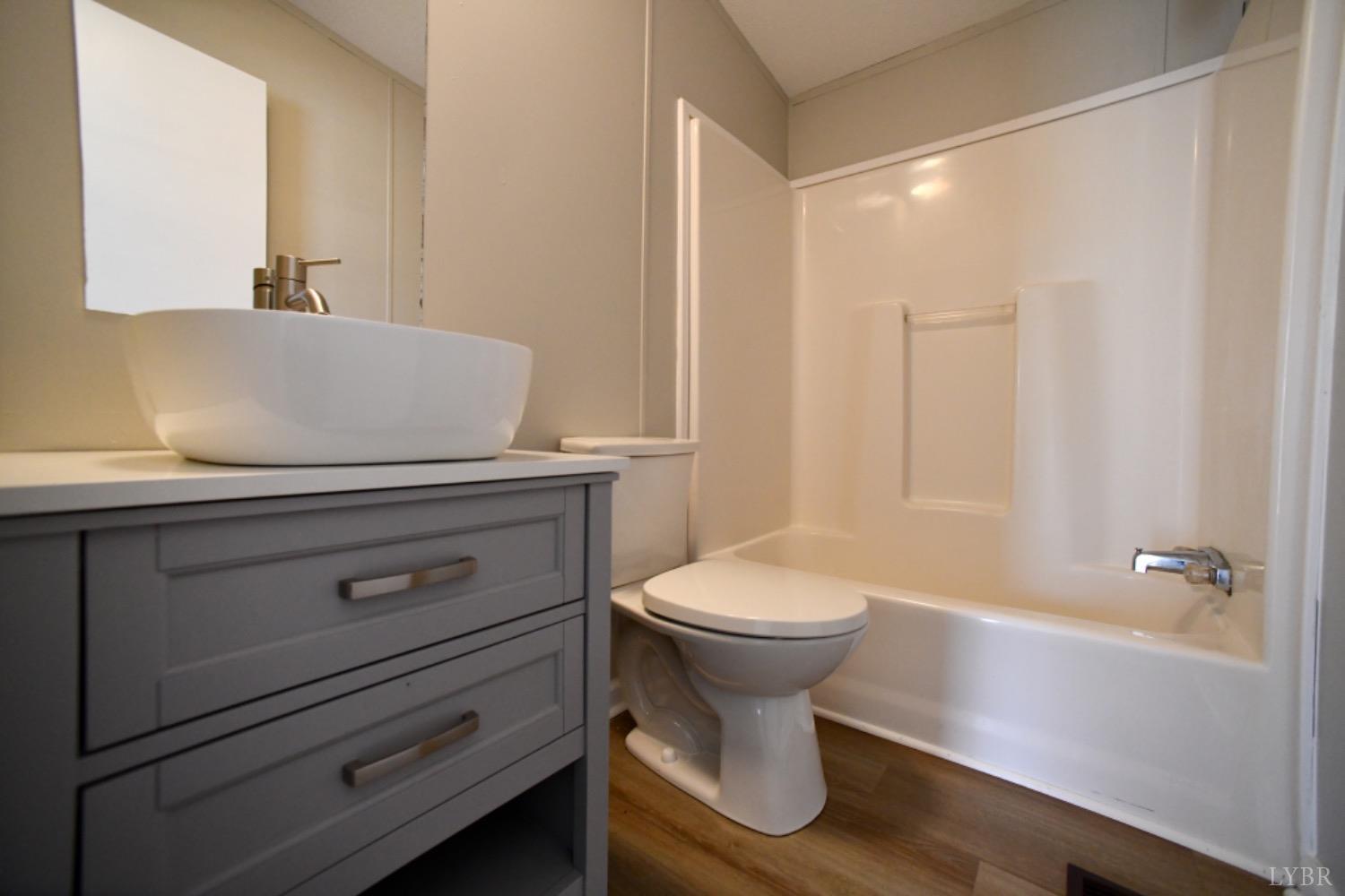 3961 Roark Mill Road Hurt, VA 24563 - Photo 24 of 28 a bathroom with a sink a toilet and shower