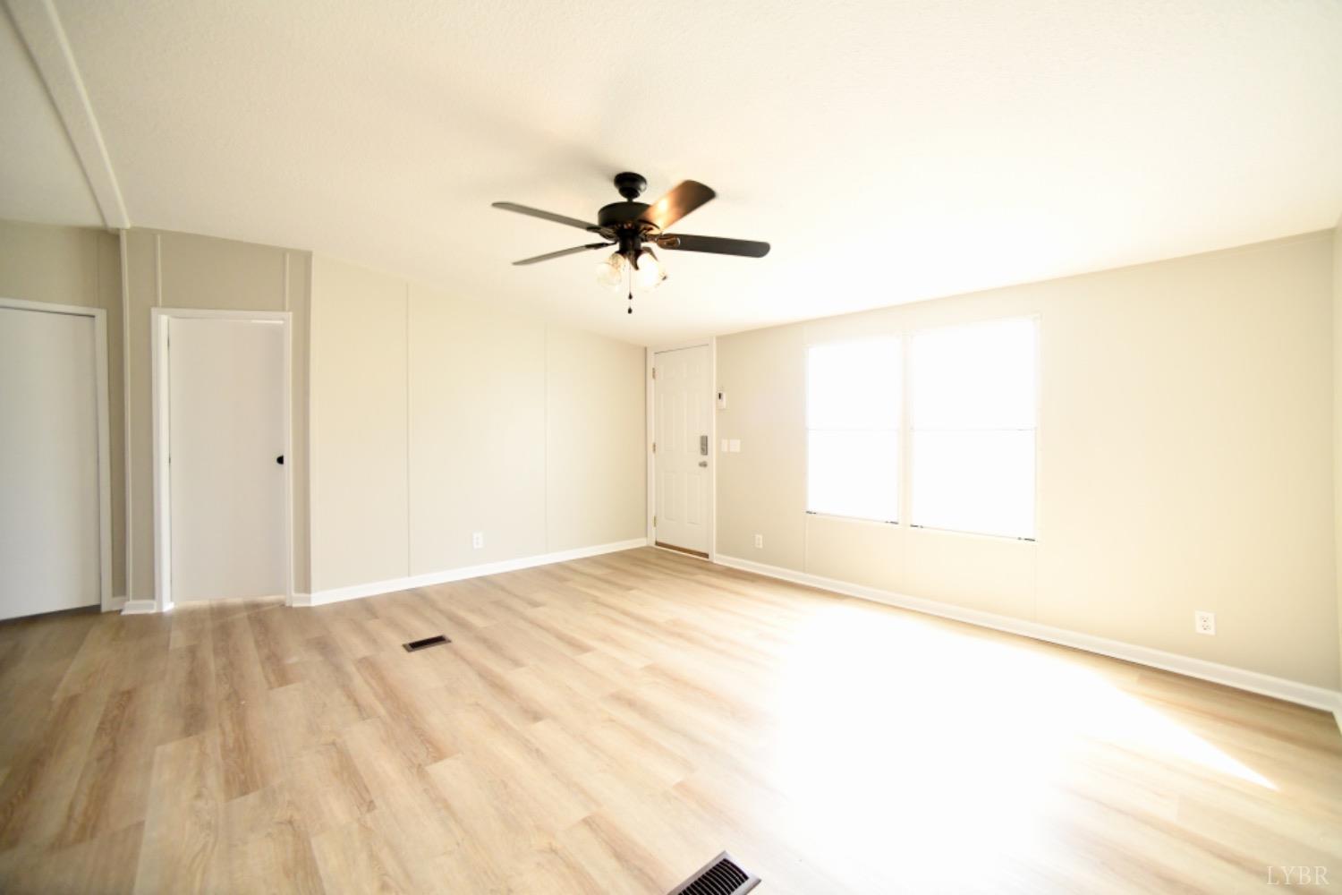3961 Roark Mill Road Hurt, VA 24563 - Photo 8 of 28 a view of a room with a ceiling fan and a window