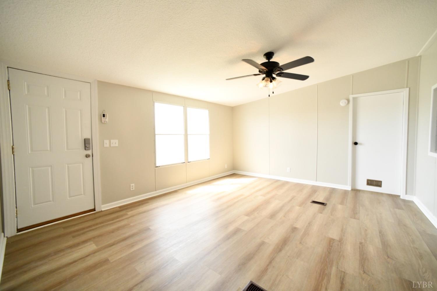 3961 Roark Mill Road Hurt, VA 24563 - Photo 10 of 28 wooden floor in an empty room with a window