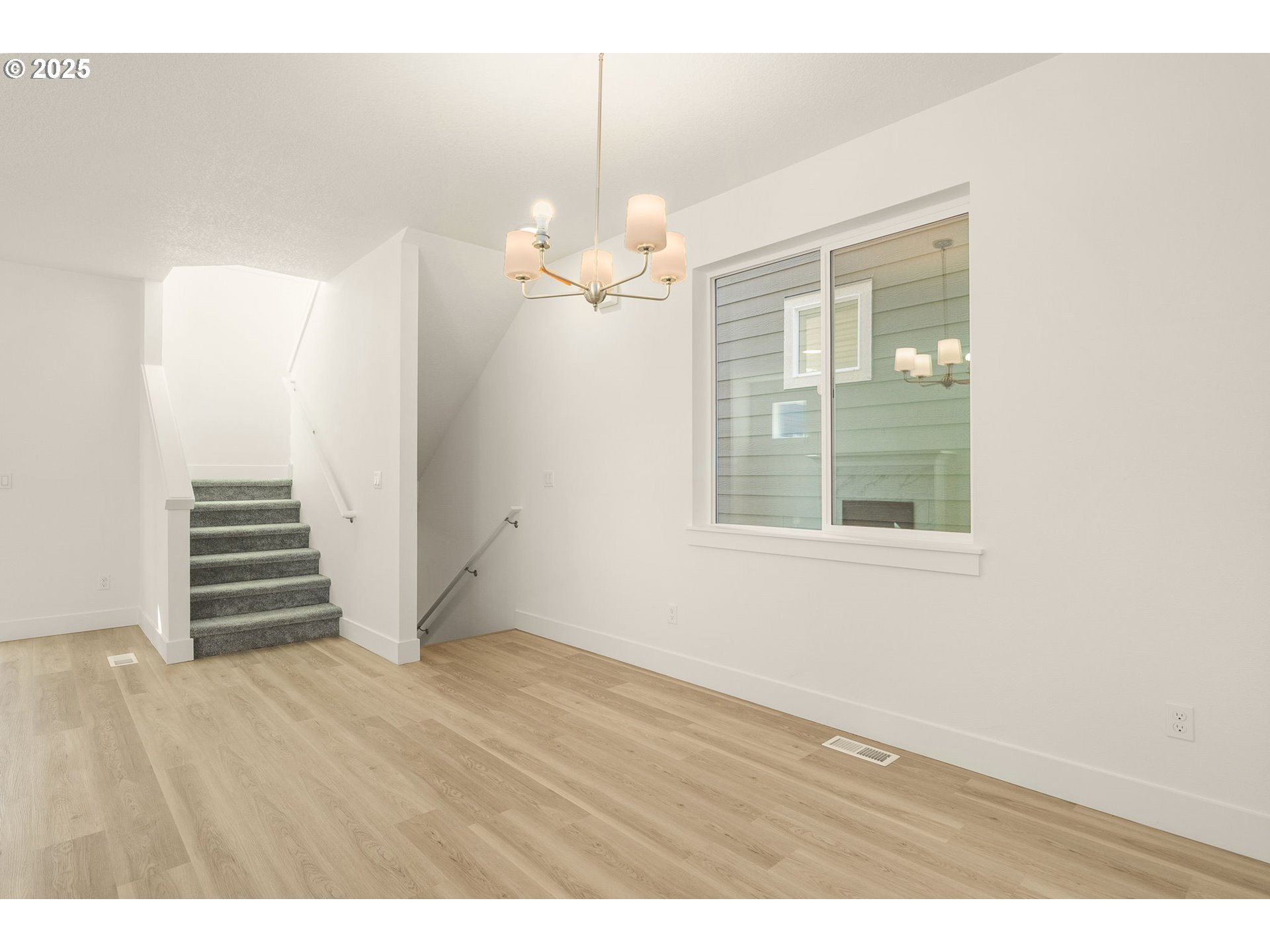 18933 Southwest Hazelwood Lane, Unit L9 Beaverton, OR 97078 - Photo 15 of 29 a view of an empty room with wooden floor and a window