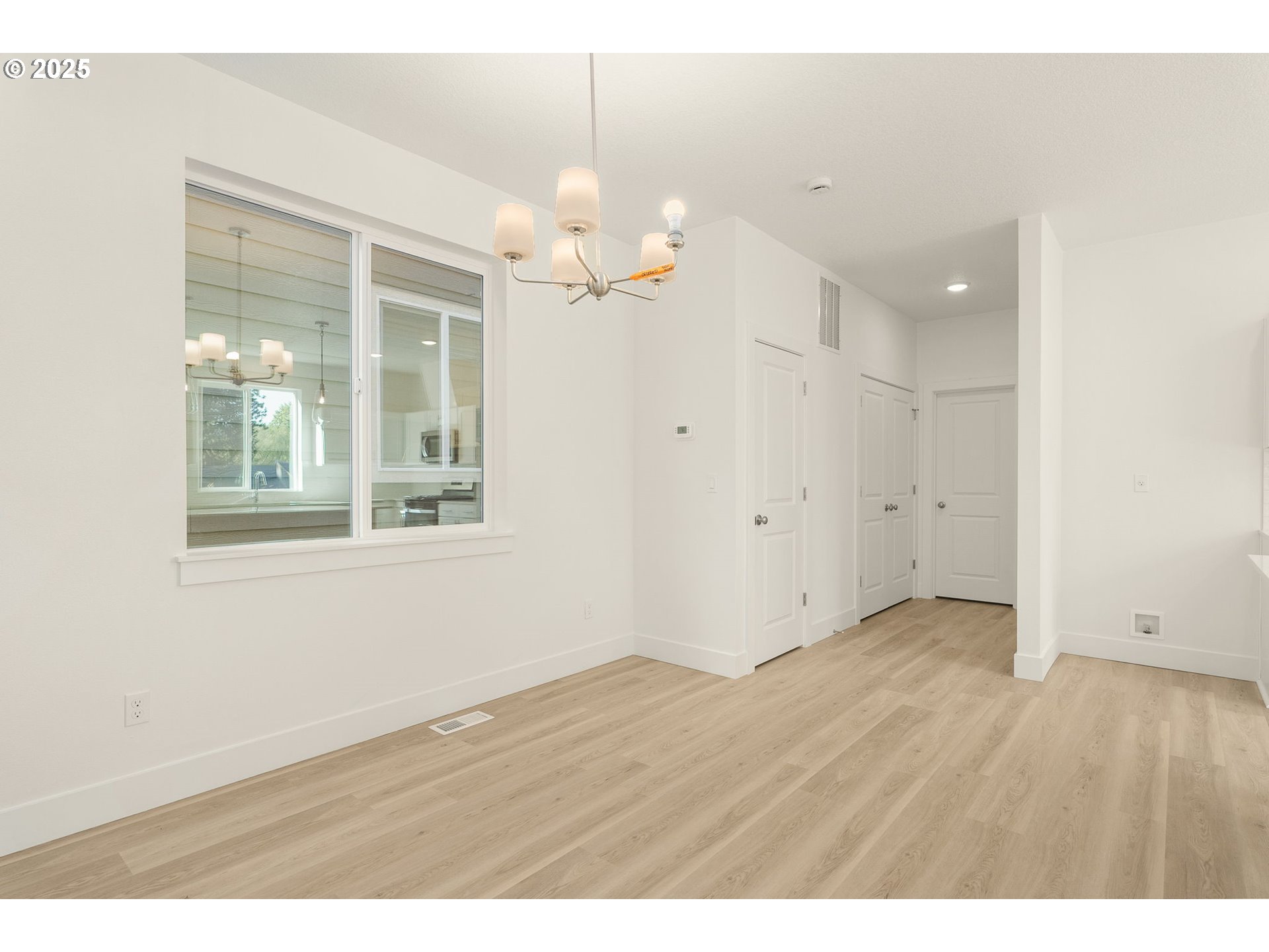 18933 Southwest Hazelwood Lane, Unit L9 Beaverton, OR 97078 - Photo 16 of 29 an empty room with wooden floor and windows