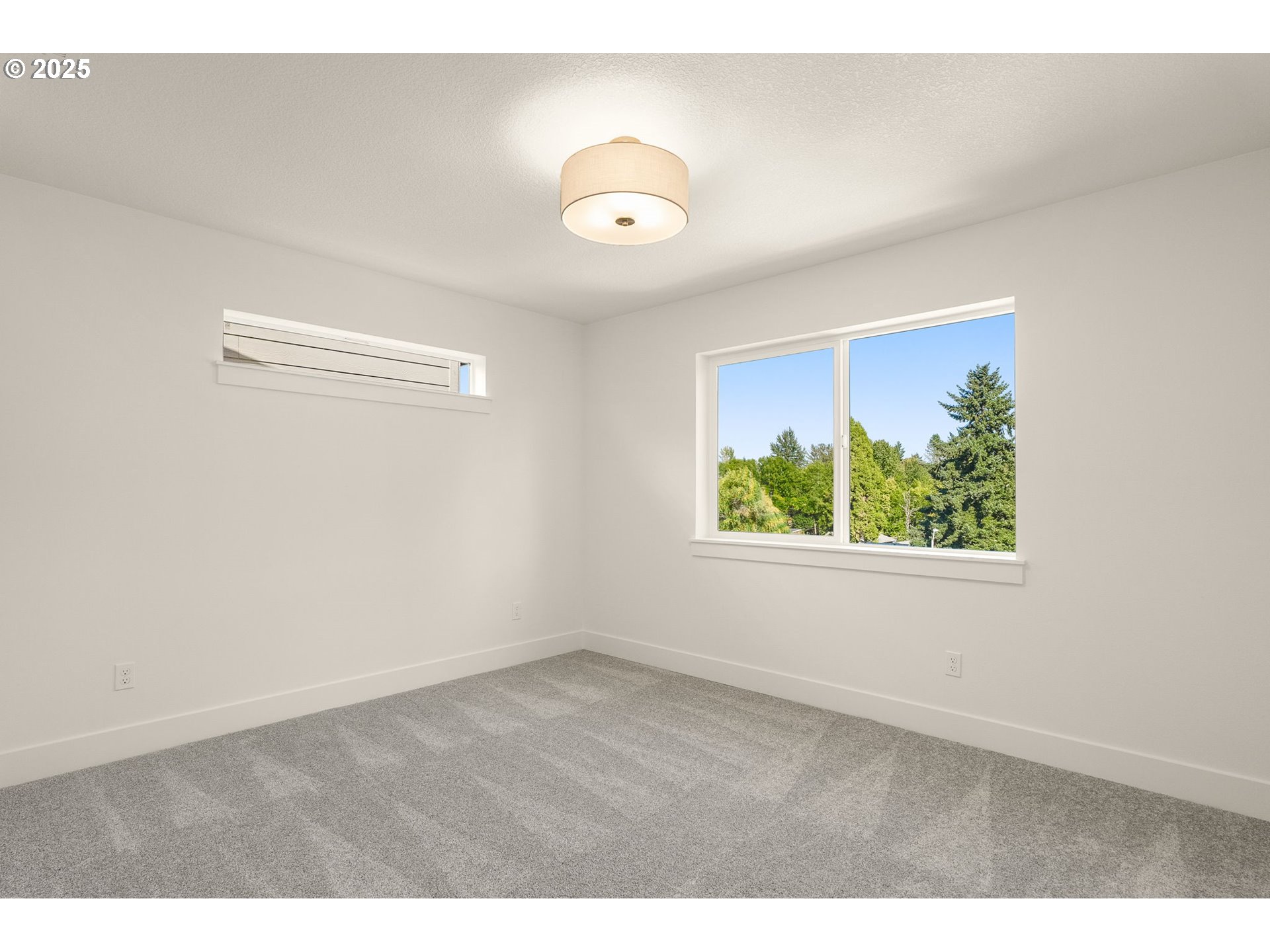 18933 Southwest Hazelwood Lane, Unit L9 Beaverton, OR 97078 - Photo 23 of 29 a view of an empty room with a window