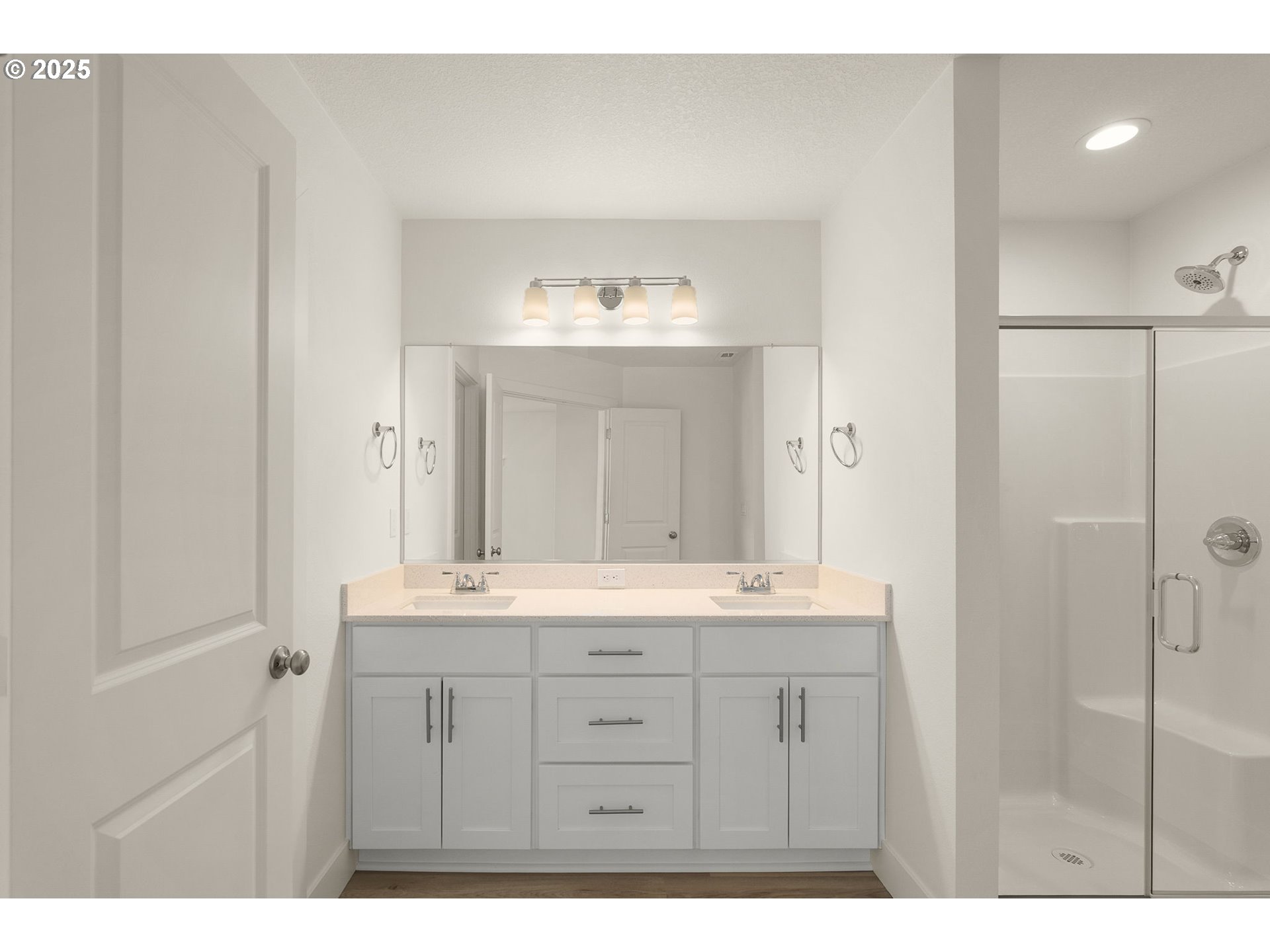 18933 Southwest Hazelwood Lane, Unit L9 Beaverton, OR 97078 - Photo 26 of 29 a bathroom with a double vanity sink and mirror