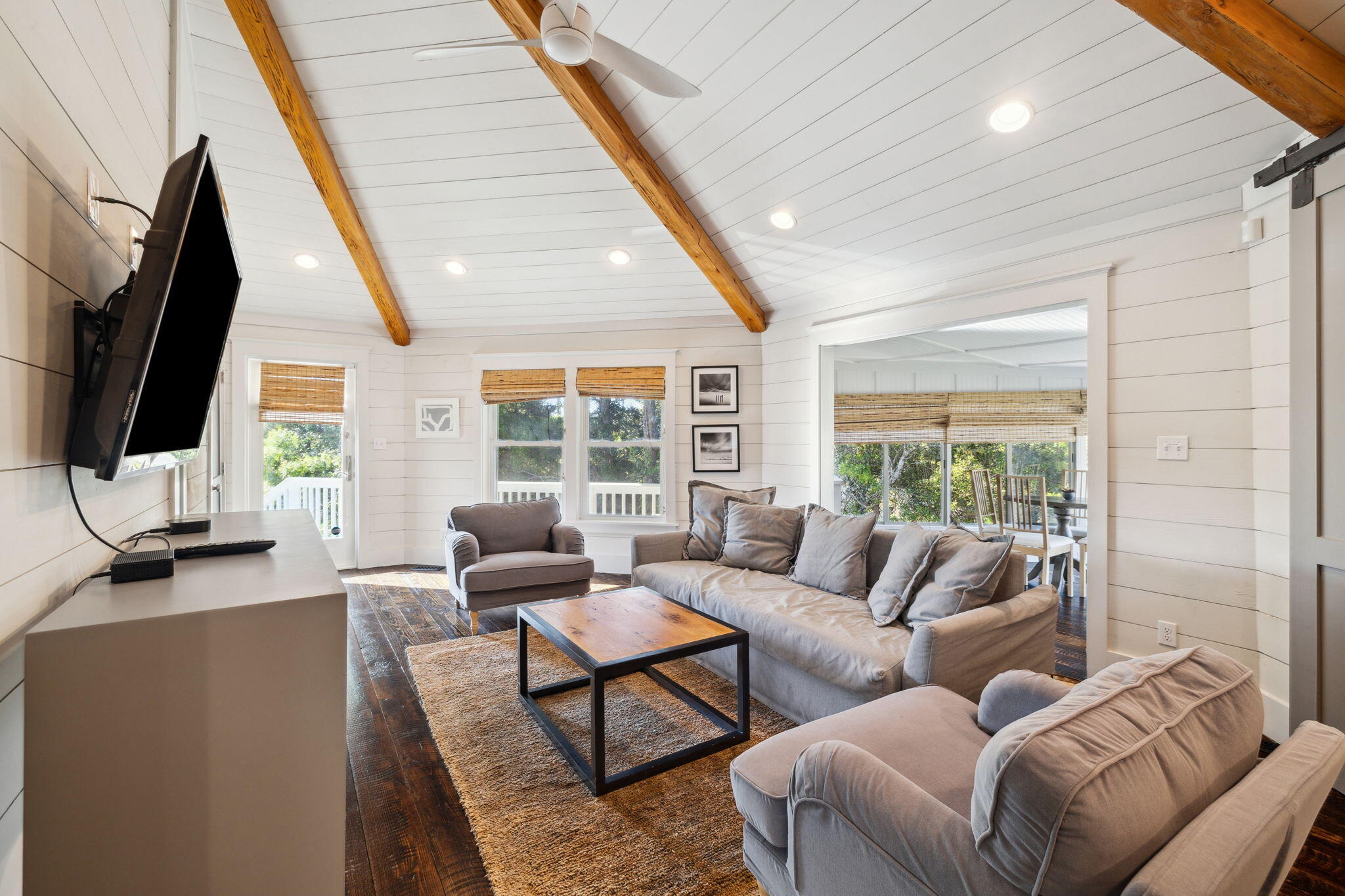 59 Montigo Avenue Santa Rosa Beach, FL 32459 - Photo 29 of 48 a living room with furniture a large window and a flat screen tv