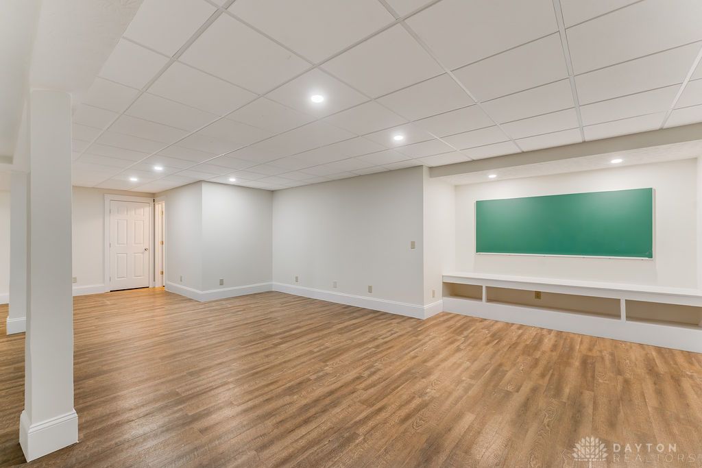 7400 Cook-Jones Road Waynesville, OH 45068 - Photo 44 of 72 This spacious, finished basement offers versatile living with durable wood flooring and ample recessed lighting.