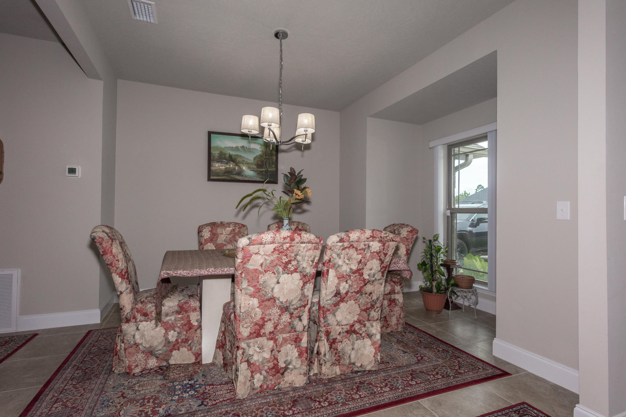 4675 Chanteuse Parkway Crestview, FL 32539 - Photo 17 of 35 a view of a dining room with furniture and chandelier
