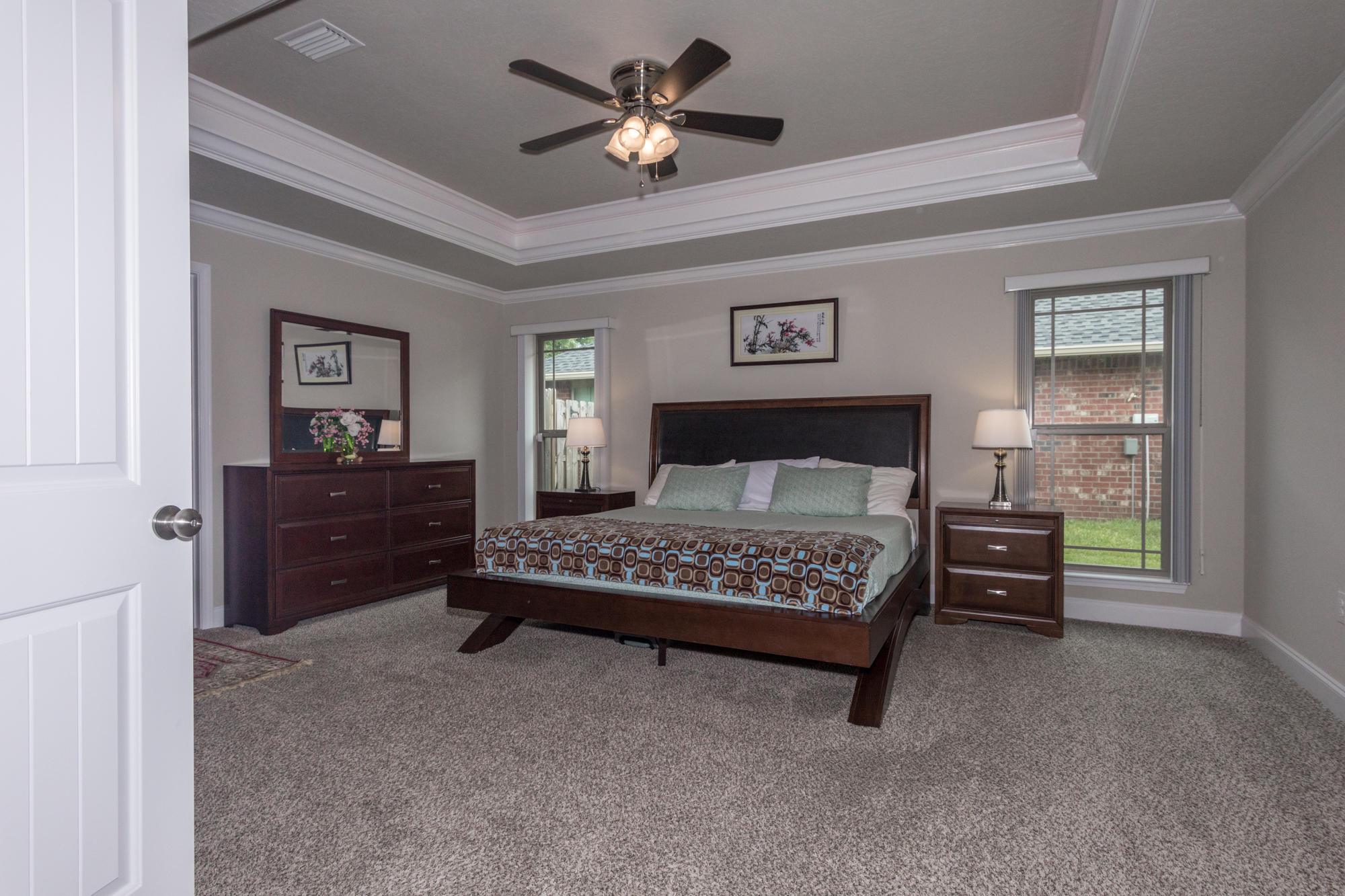 4675 Chanteuse Parkway Crestview, FL 32539 - Photo 18 of 35 a bedroom with a bed and a chandelier