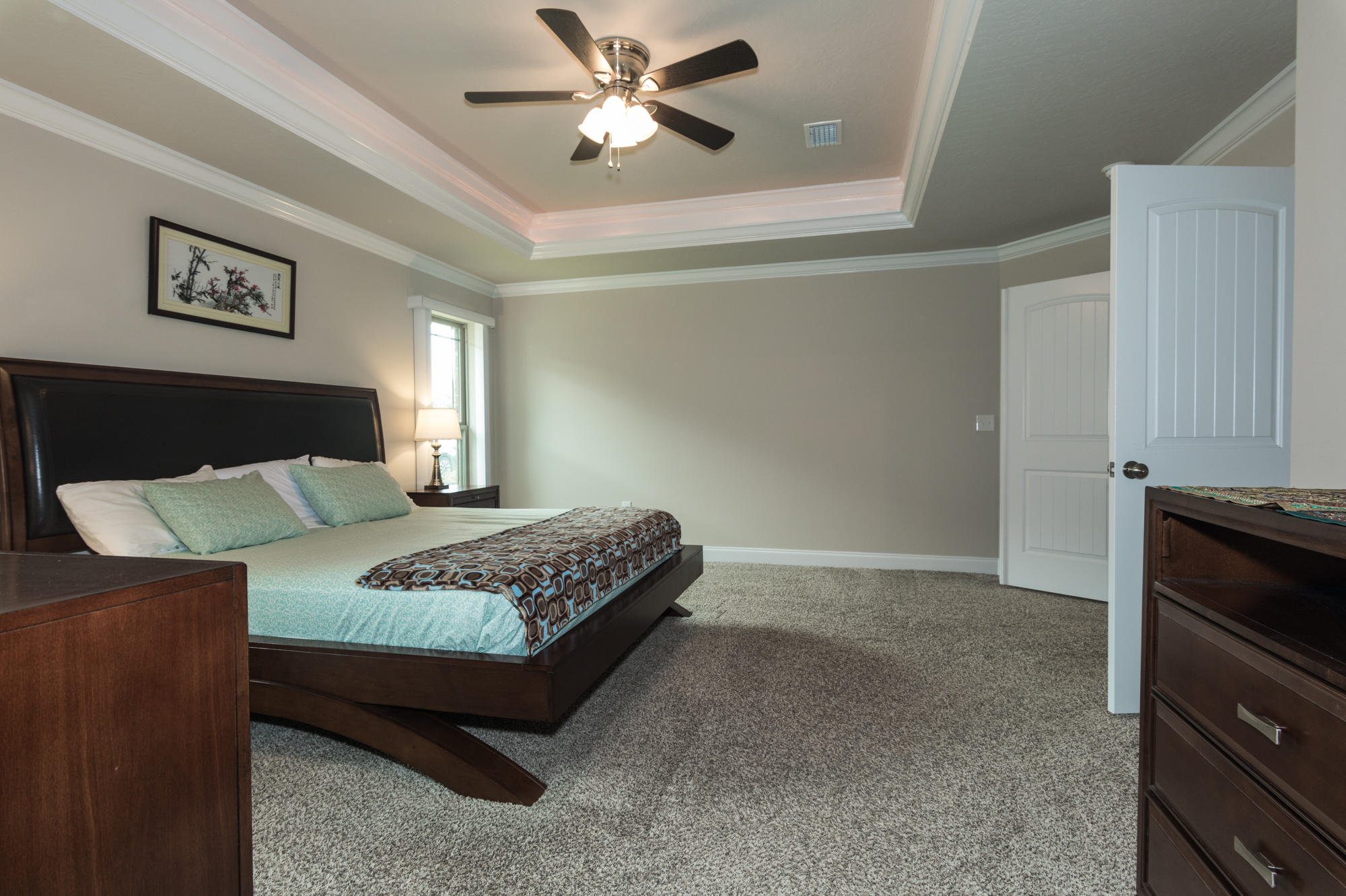 4675 Chanteuse Parkway Crestview, FL 32539 - Photo 19 of 35 a bedroom with a bed and a chandelier