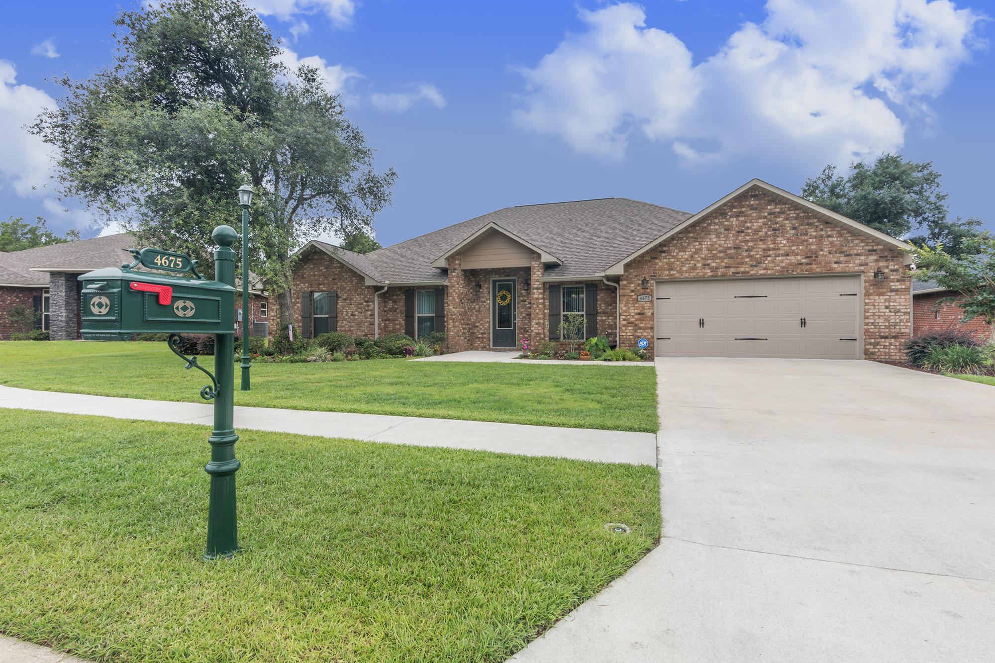 4675 Chanteuse Parkway Crestview, FL 32539 - Photo 3 of 35 a front view of a house with a yard and trees