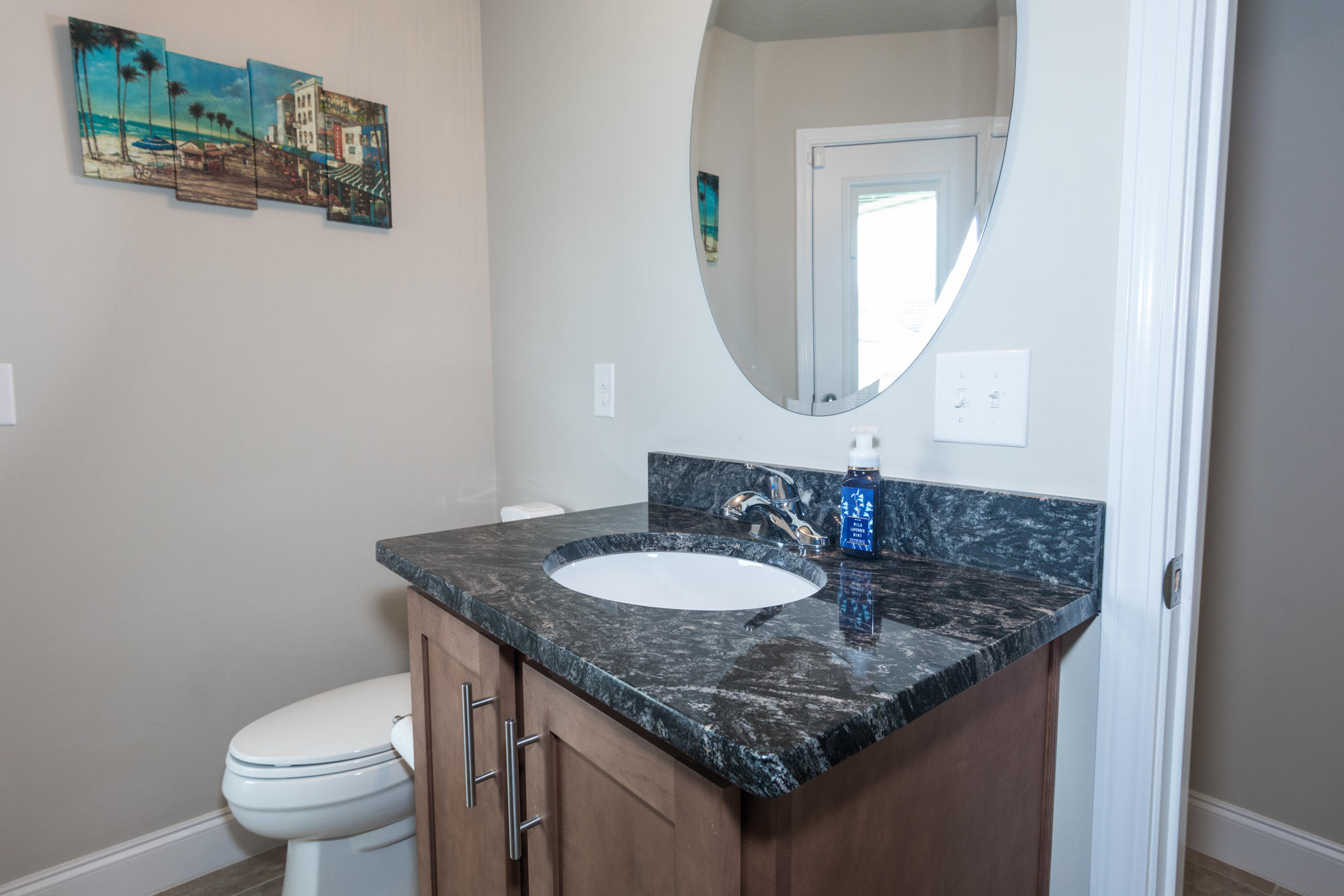 4675 Chanteuse Parkway Crestview, FL 32539 - Photo 26 of 35 a bathroom with a granite countertop sink a toilet and a mirror