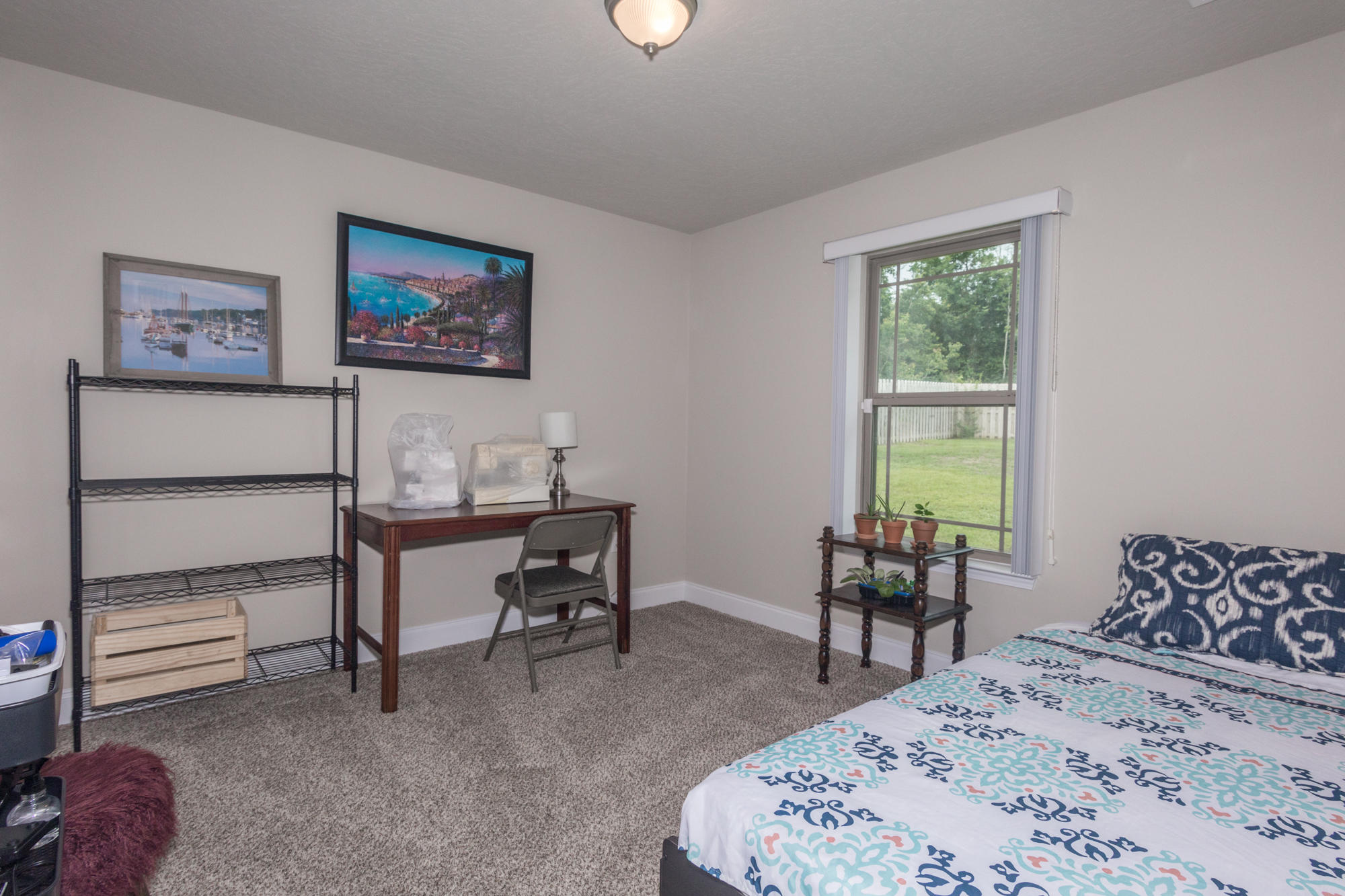 4675 Chanteuse Parkway Crestview, FL 32539 - Photo 29 of 35 a bedroom with a bed and a table in it