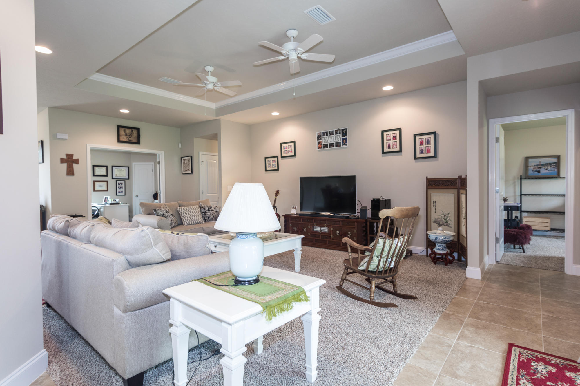 4675 Chanteuse Parkway Crestview, FL 32539 - Photo 8 of 35 a living room with furniture a flat screen tv and a table