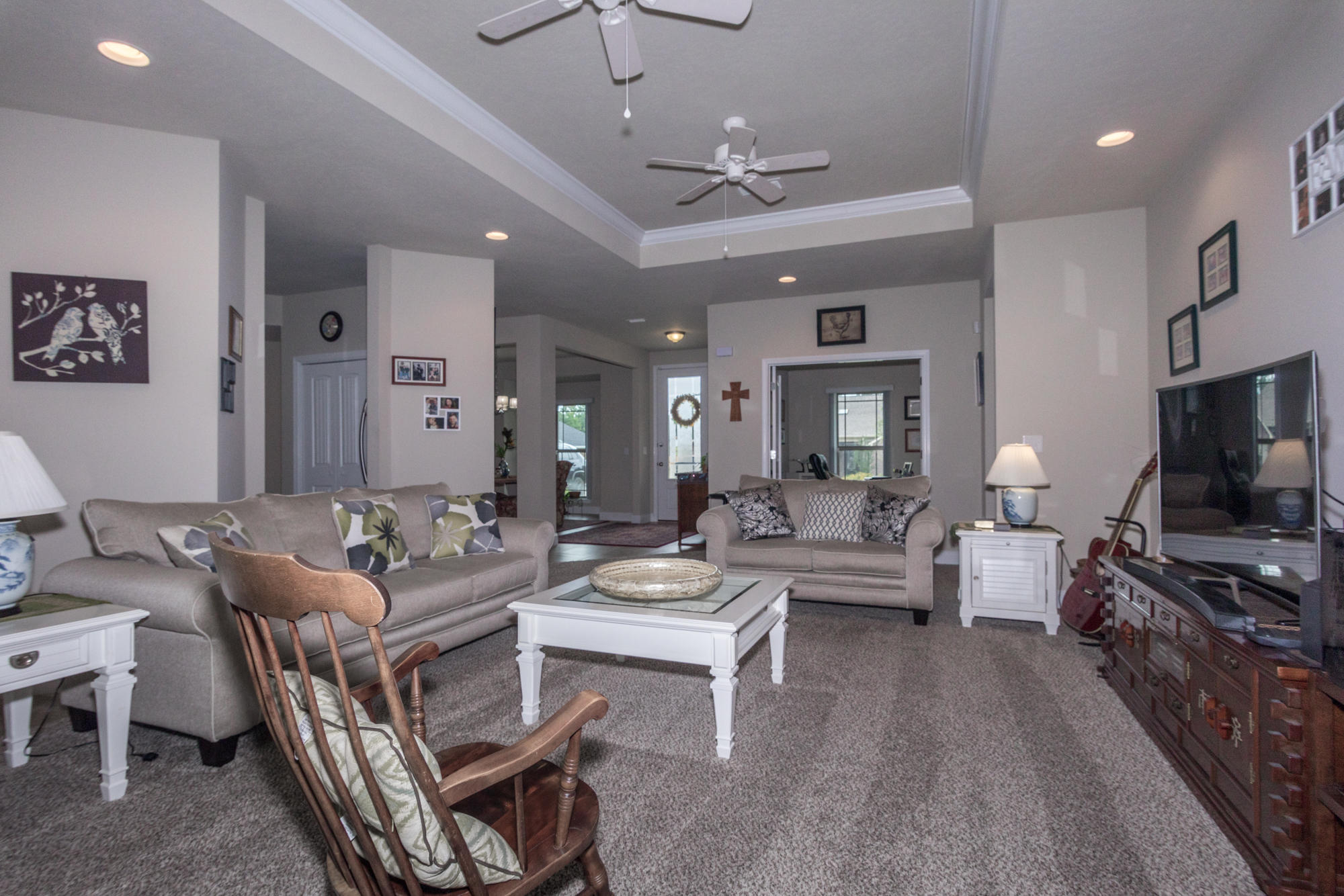 4675 Chanteuse Parkway Crestview, FL 32539 - Photo 10 of 35 a living room with furniture a flat screen tv and kitchen view