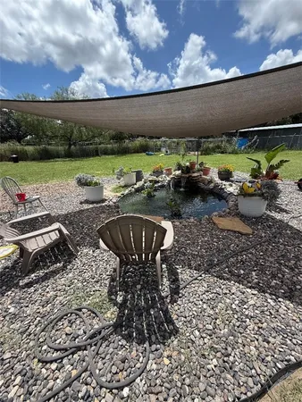 a view of a chairs and table in the patio