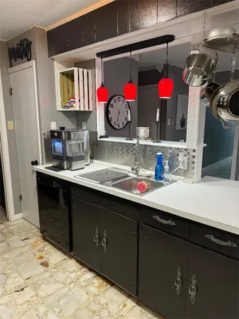 a room with sink and cabinets