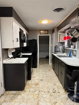 a kitchen with stainless steel appliances kitchen island granite countertop a sink stove and cabinets