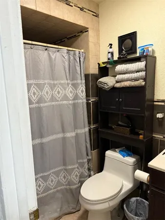 a bathroom with a toilet and a shower