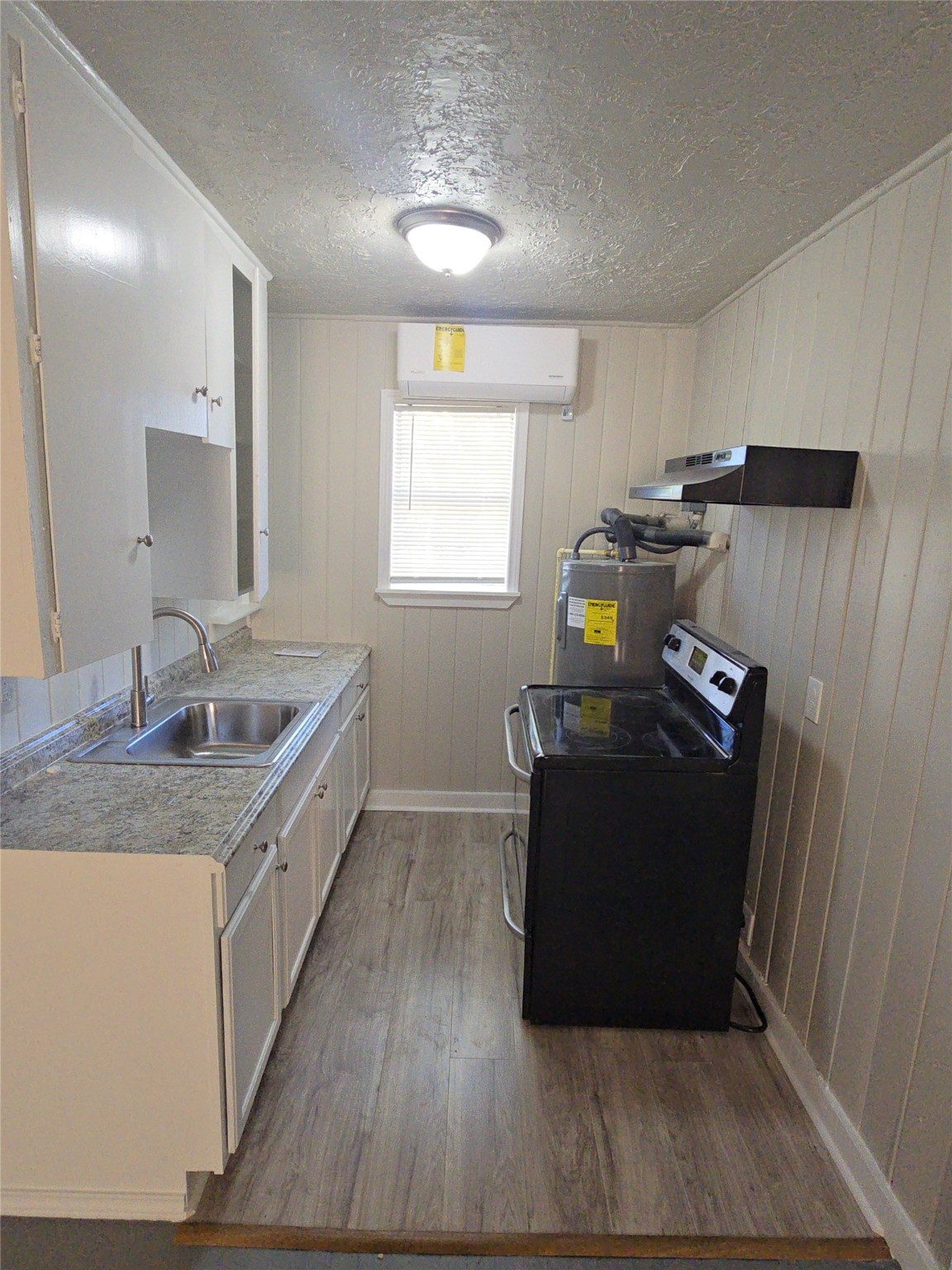 3335 Tuam Street, Unit 3 Houston, TX 77004 - Photo 12 of 16 a kitchen with a sink and wooden floor
