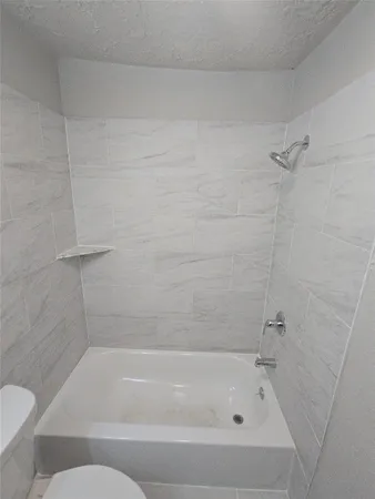 a bathroom with a bathtub and a toilet