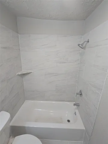 a bathroom with a bathtub and a toilet